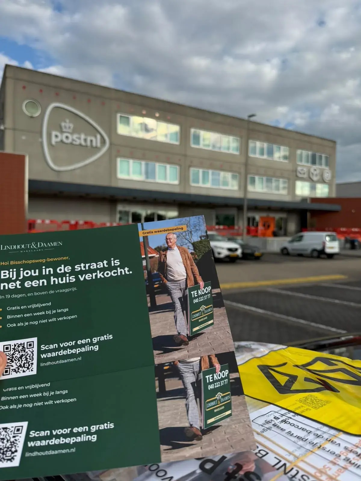 Lindhout & Daamen postcards in front of a PostNL sorting centre
