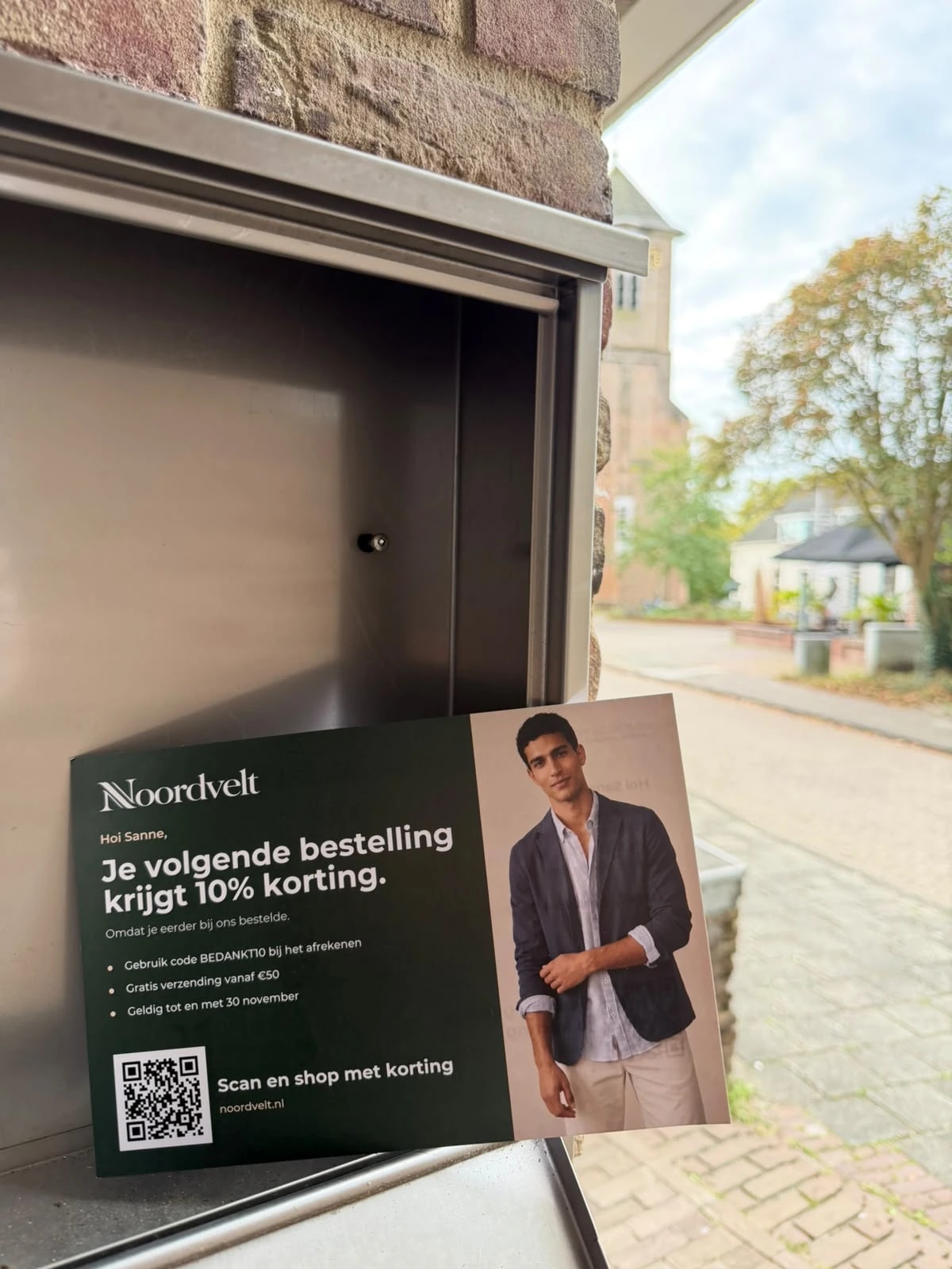 Noordvelt postcard with a 10% reorder code, delivered to a letterbox