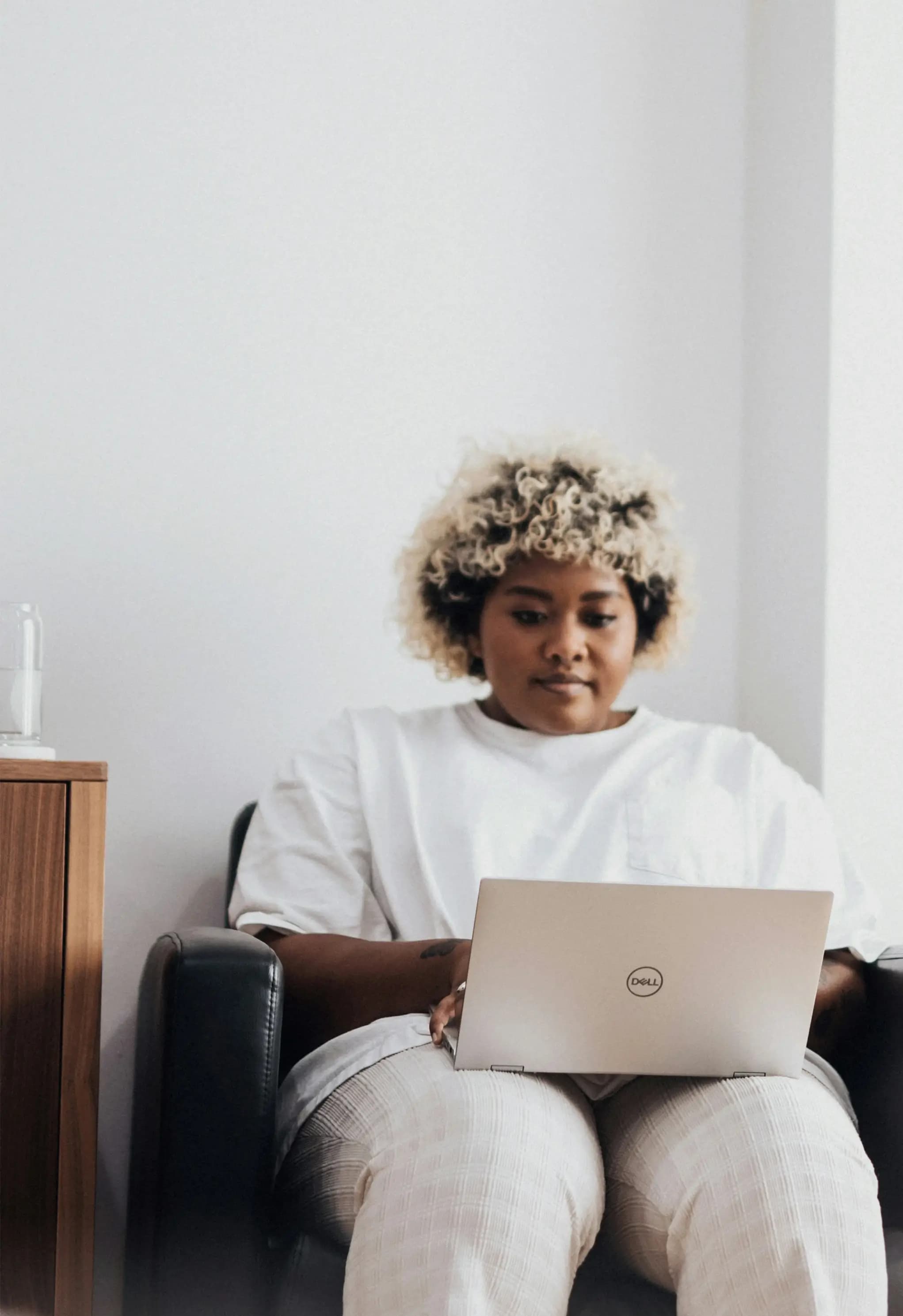Clinic team member reviewing patient feedback on a laptop