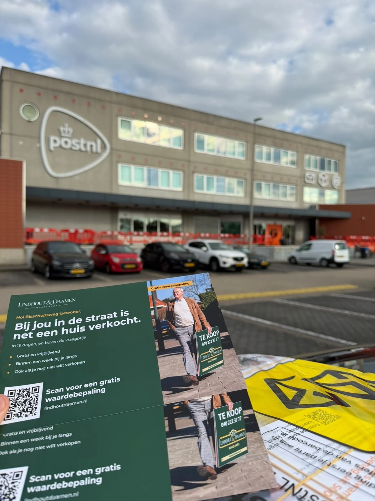 Lindhout & Daamen postcards in front of a PostNL sorting centre