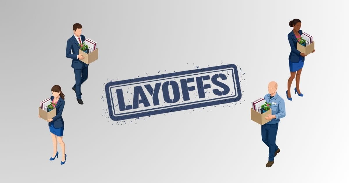 A laid-off library worker sits at a desk updating their resume on a laptop, preparing for a career transition after a public sector layoff in 2026.