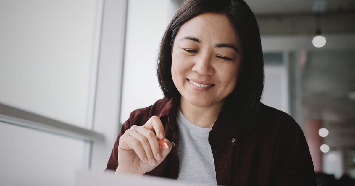 Woman reviewing resume and considering whether to include references.