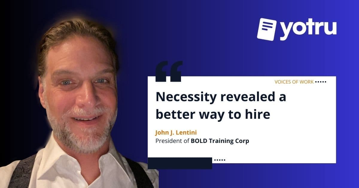 Senior executive reviewing resumes while leading high-volume hiring initiative