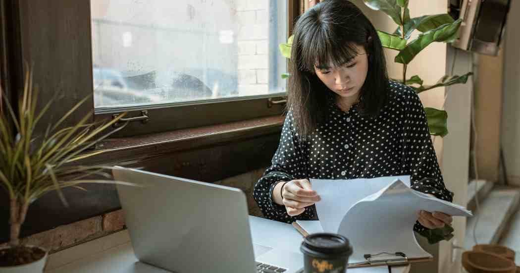 team-member-going-through-exective-assistant-report