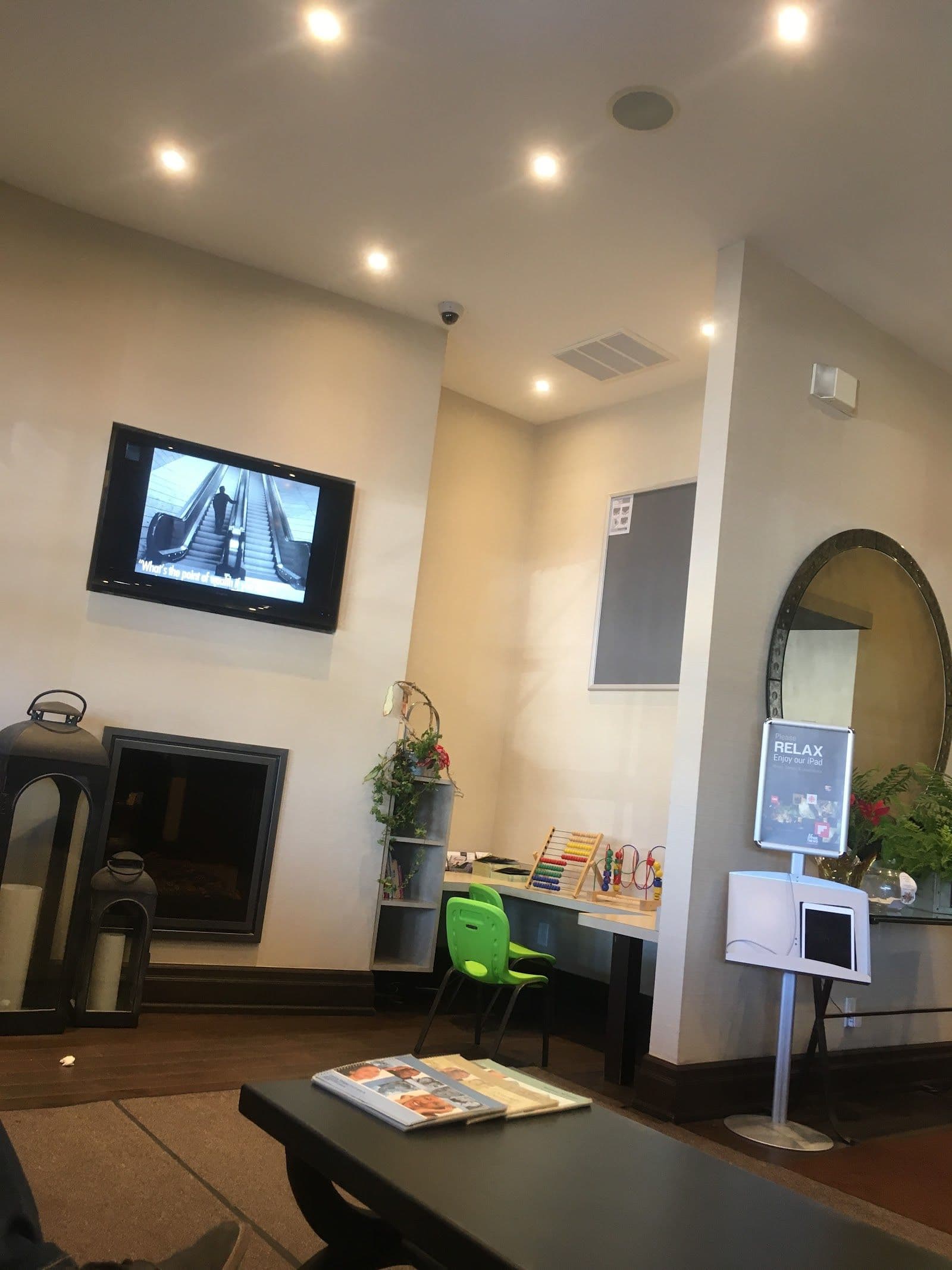 Dental clinic front desk team reviewing patient feedback together on a tablet at the reception desk