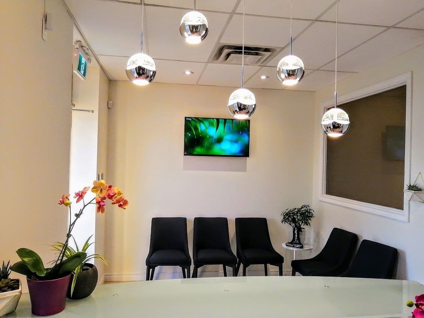 Clinic team at Myhealth Flow in Brampton reviewing patient feedback together at the front desk