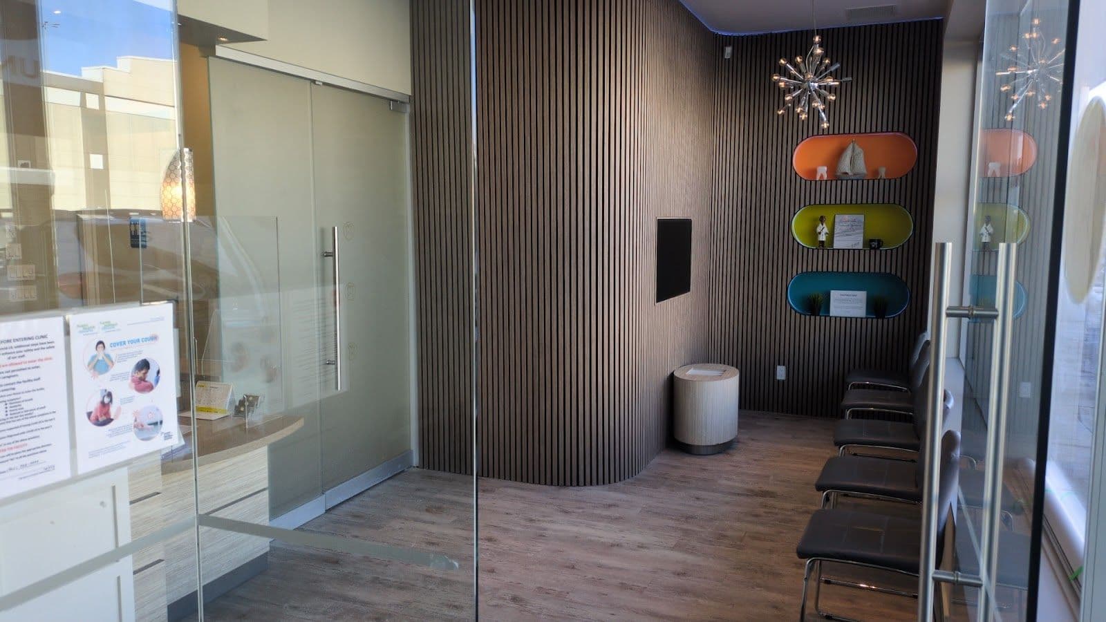 A dental clinic front desk team reviewing patient feedback on a tablet together in a clean, modern reception area