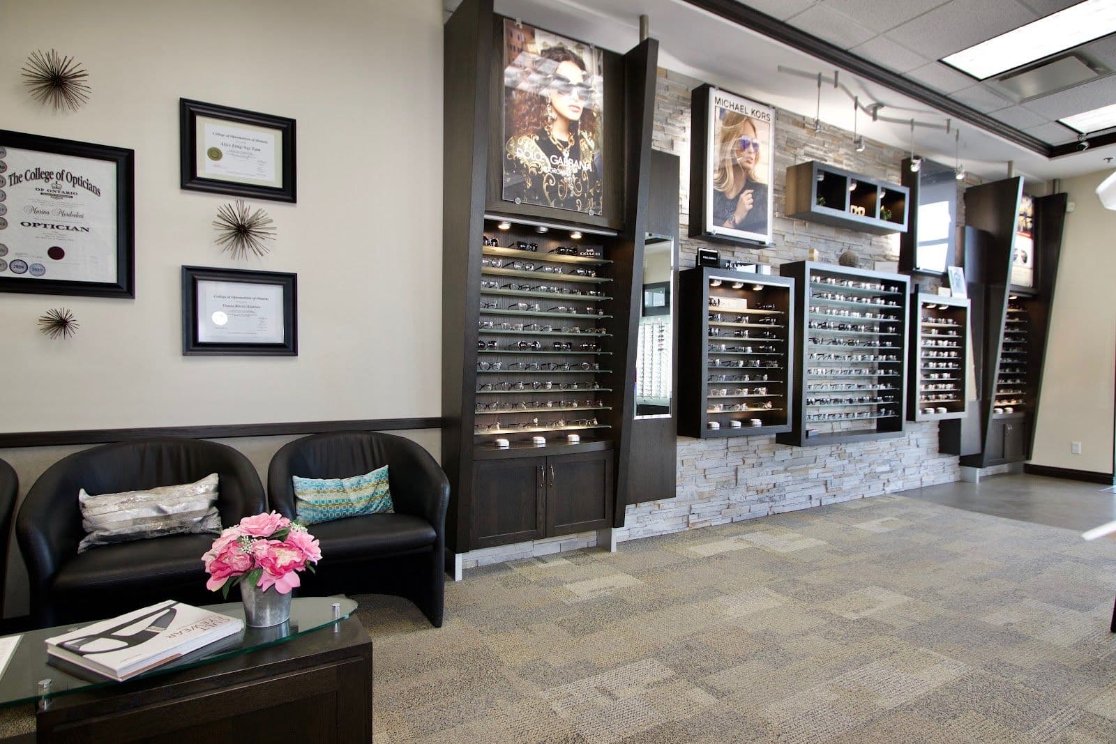 Optometry clinic team reviewing patient feedback together at the front desk, with a computer screen showing Google review summaries