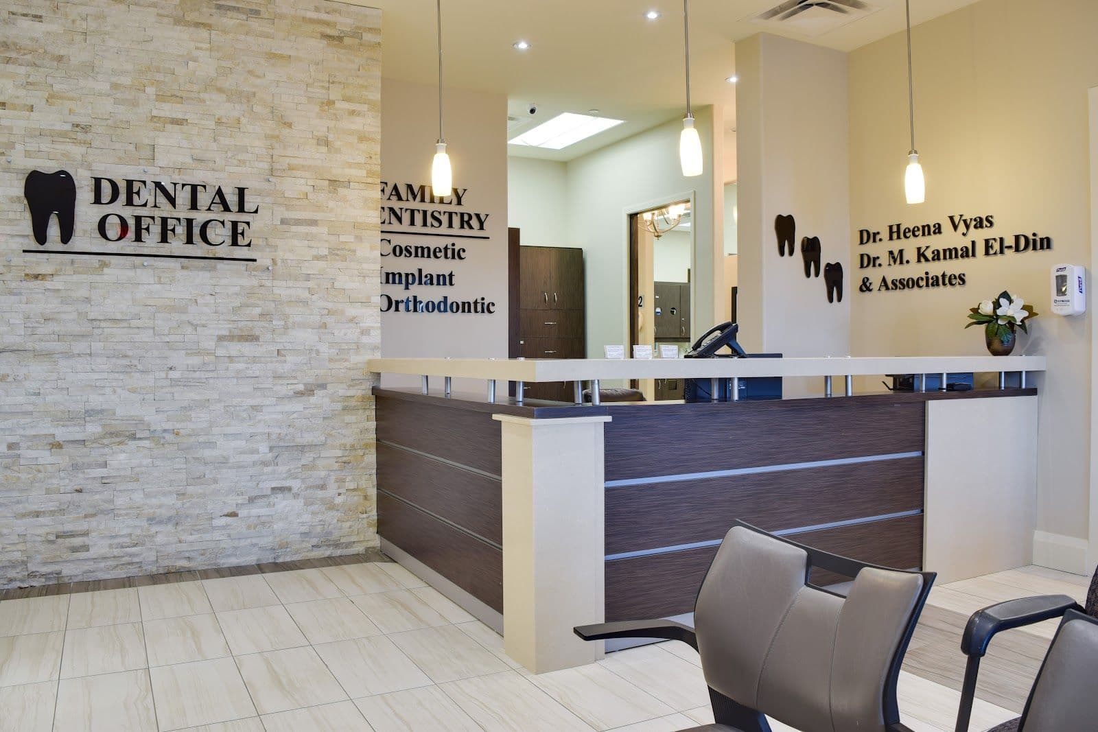 Dental clinic front desk team reviewing patient feedback on a tablet together at the reception counter