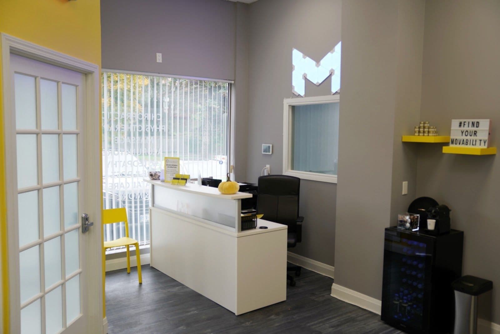 Clinic team at Movability reviewing patient feedback and Google reviews together at the front desk