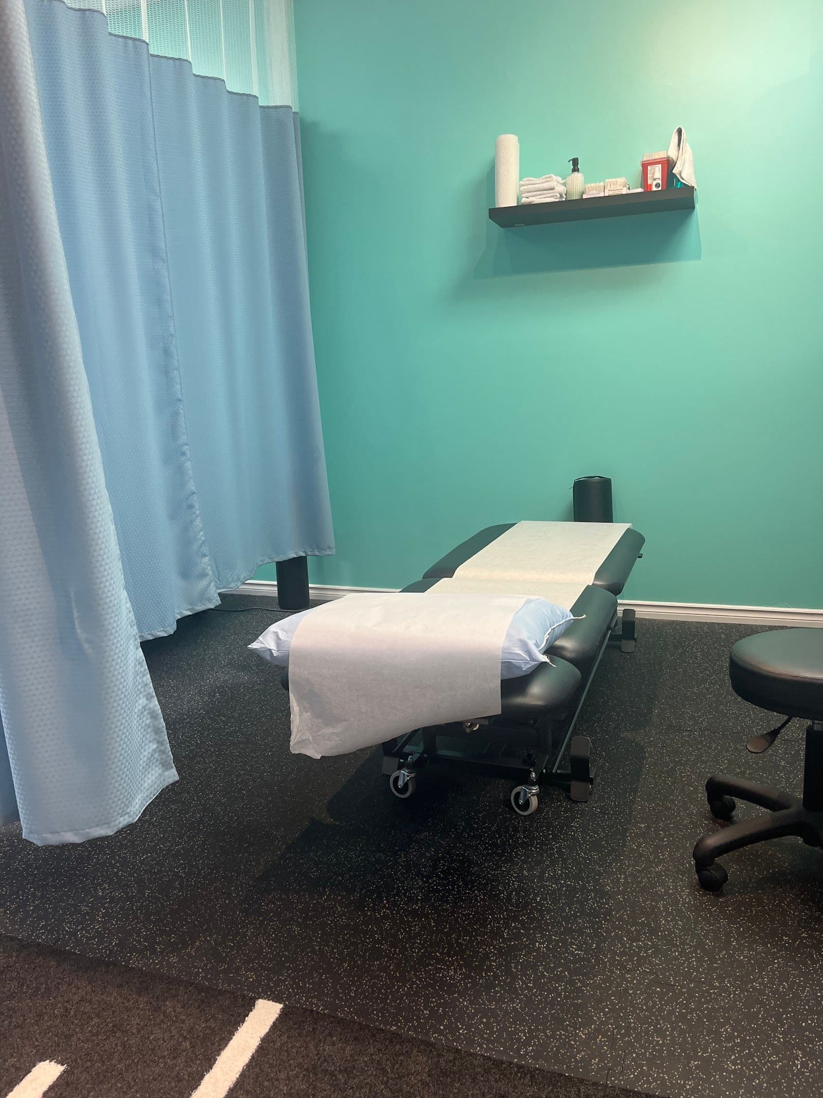 A physiotherapy clinic front desk team reviewing patient feedback and Google reviews together on a tablet at the reception counter