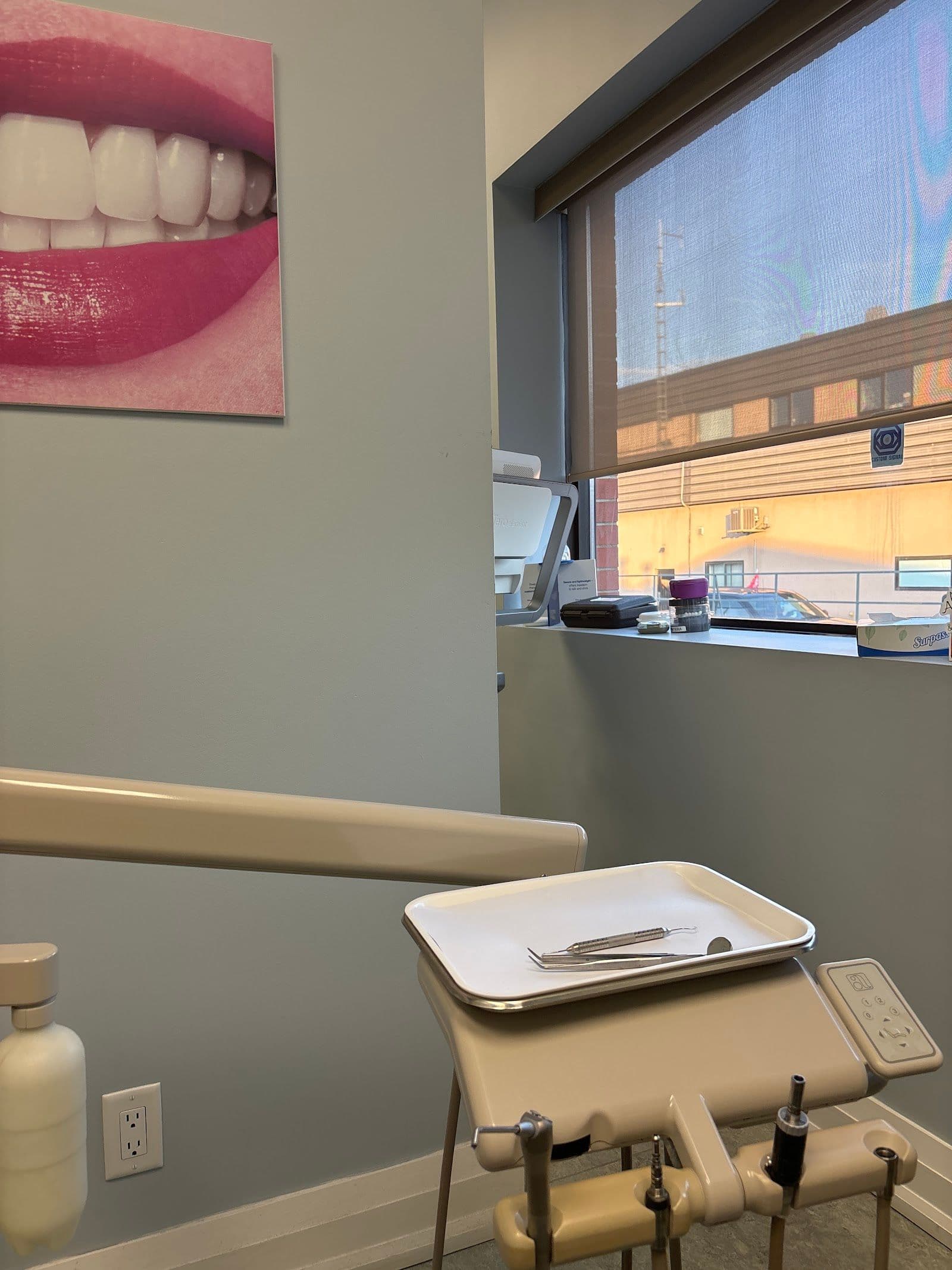 Dental clinic front desk team reviewing patient feedback on a tablet in a clean, welcoming reception area