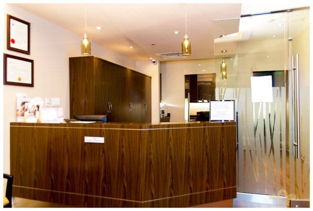 Bristol Dental Clinic front desk team reviewing patient feedback together on a tablet at the reception area