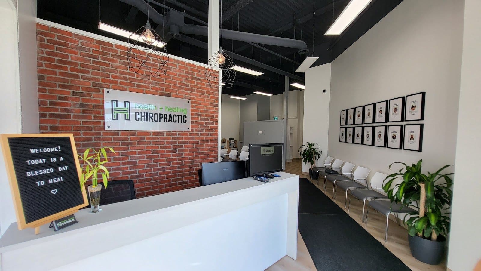 Chiropractic clinic front desk team reviewing patient feedback and Google ratings together on a tablet in a bright, welcoming reception area
