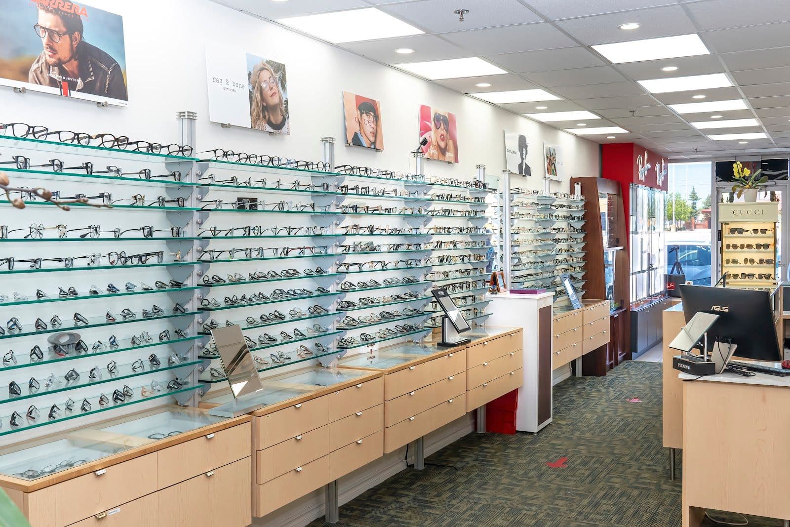 Optical clinic team reviewing patient feedback and Google reviews together at the front desk of an eyewear practice