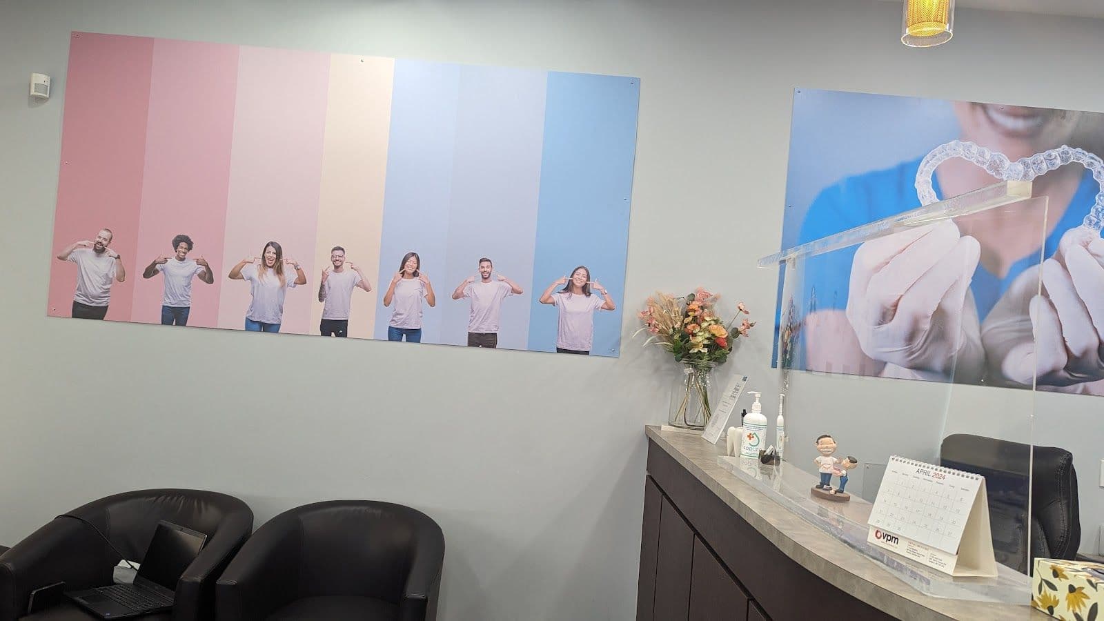 Dental clinic front desk team reviewing patient feedback on a tablet in a clean, modern reception area
