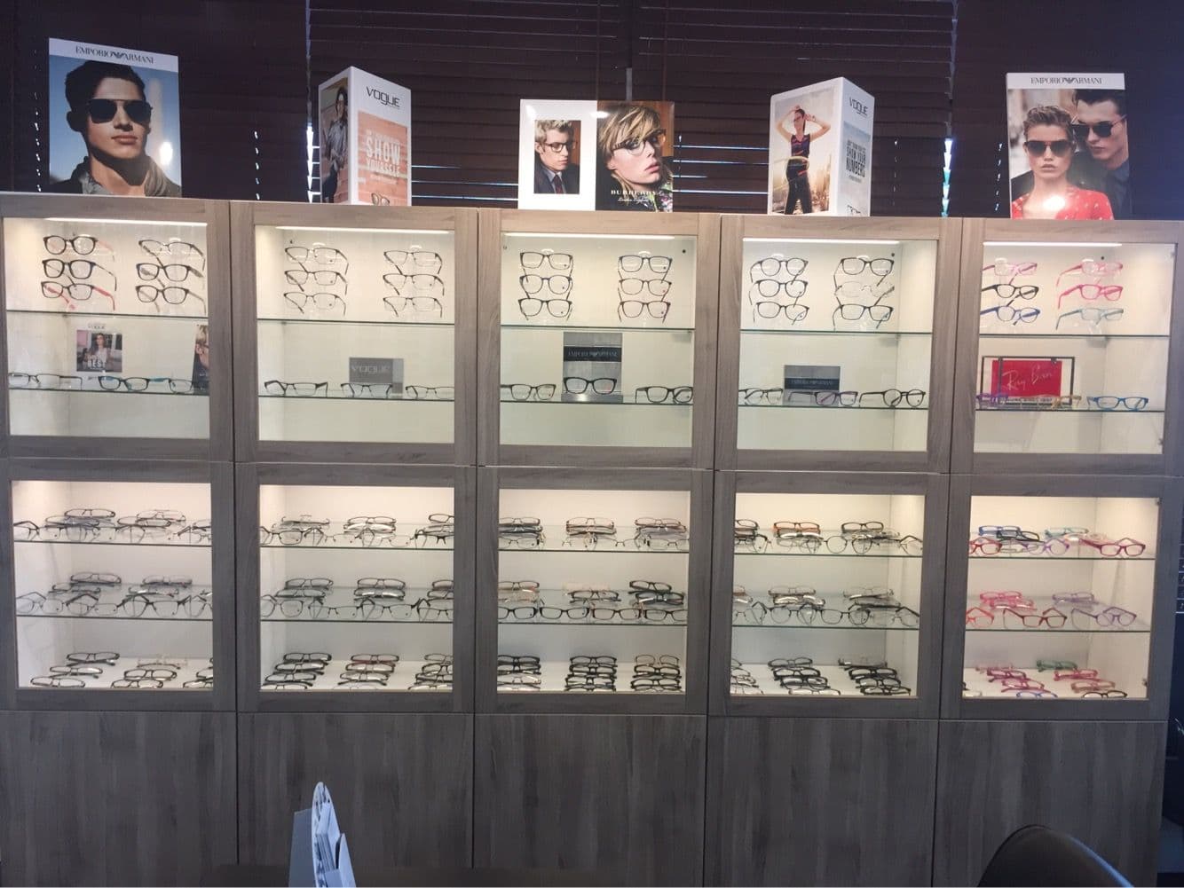 Optometry clinic team reviewing patient feedback and Google reviews together at the front desk