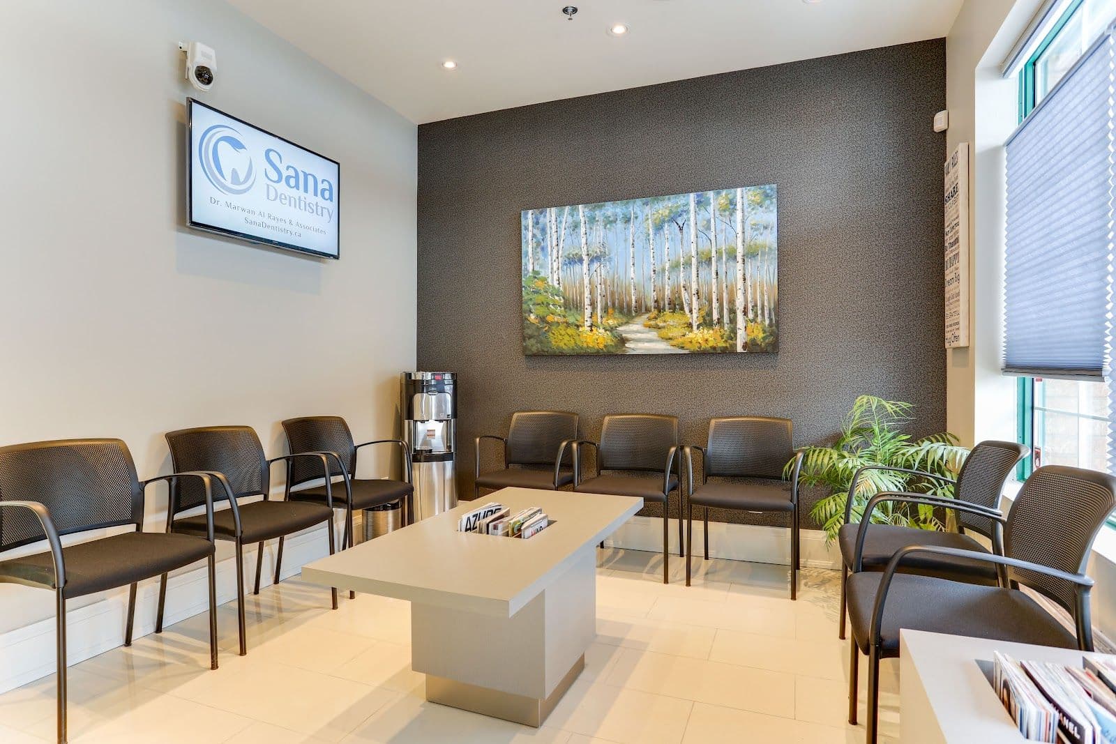 Dental clinic front desk team reviewing patient feedback together on a tablet at the reception counter