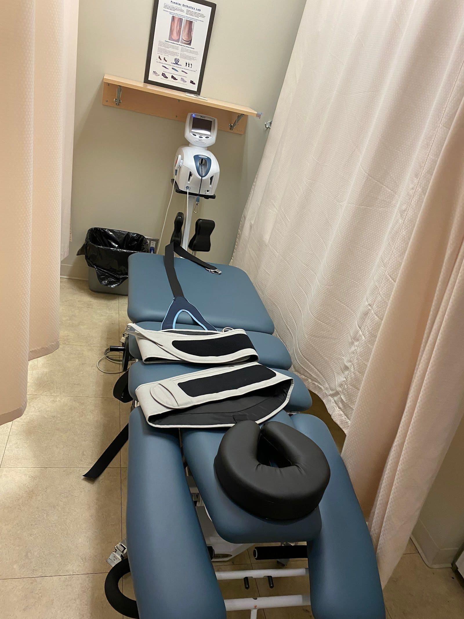 A physiotherapy clinic team member reviewing patient feedback on a tablet at the front desk of a calm, professional wellness clinic