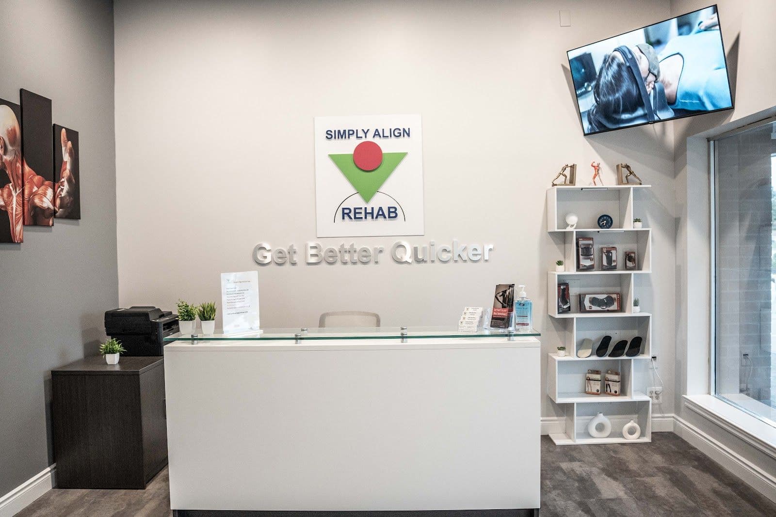 Simply Align Rehab Vaughan clinic team reviewing patient feedback together at the front desk