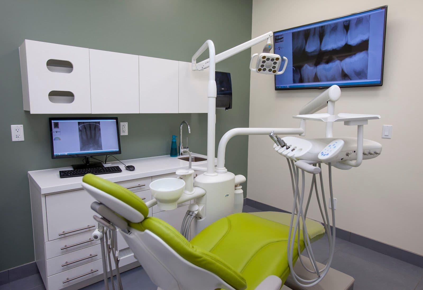 Dental clinic front desk team reviewing patient feedback on a tablet at the reception area of Toothworks at Square One