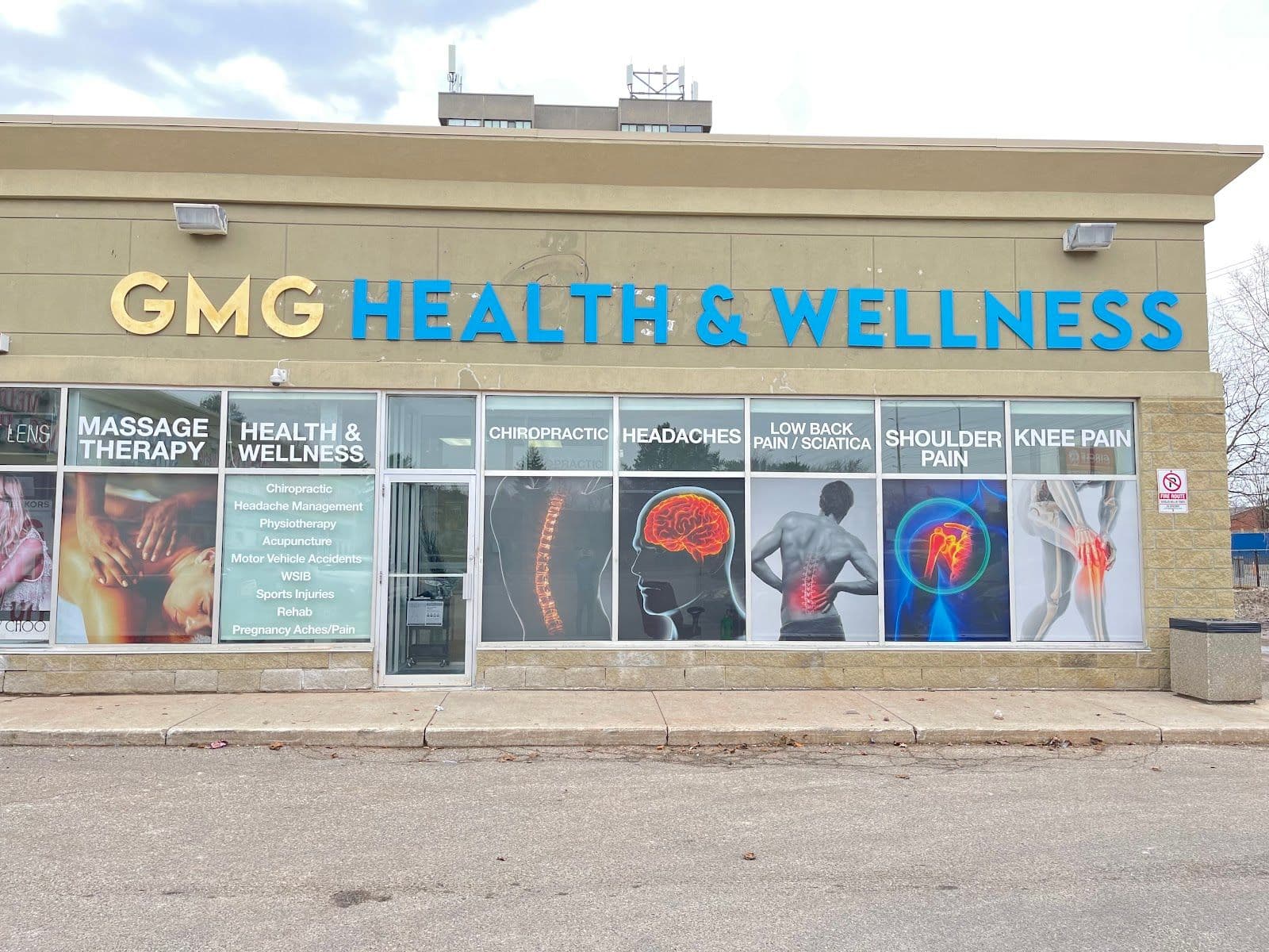 A clinic team member reviewing patient feedback on a tablet at the GMG Health and Wellness front desk, with a bright welcoming reception area in the background