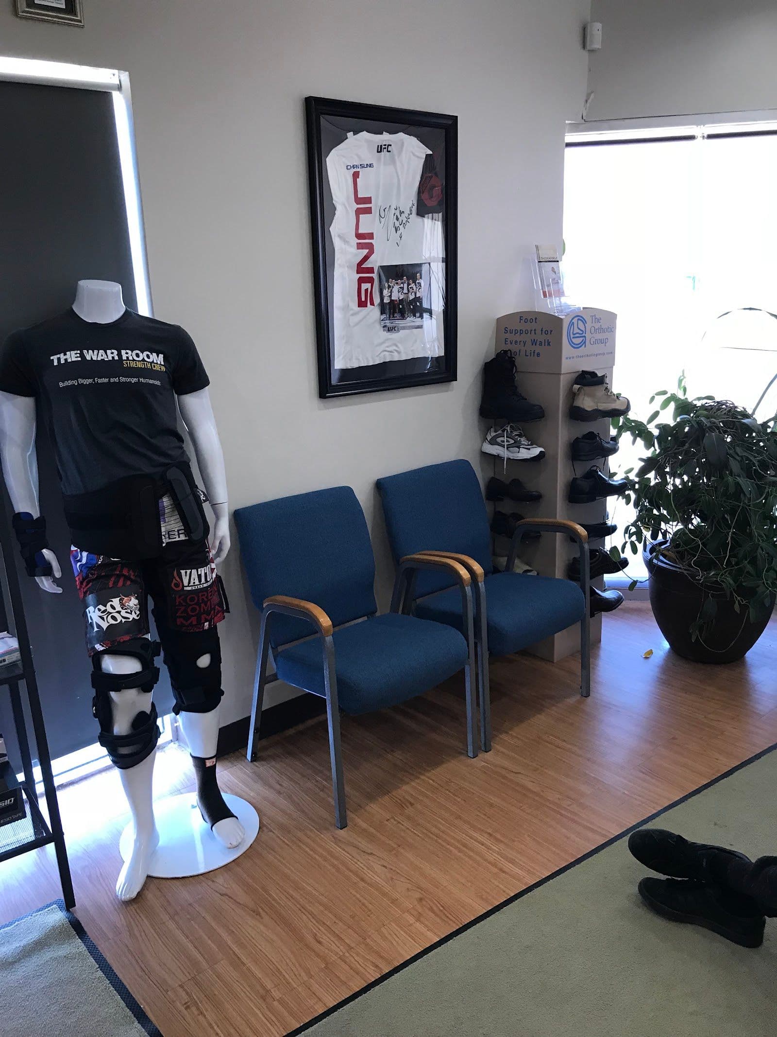 A chiropractic clinic team reviewing patient feedback and Google reviews together at the front desk