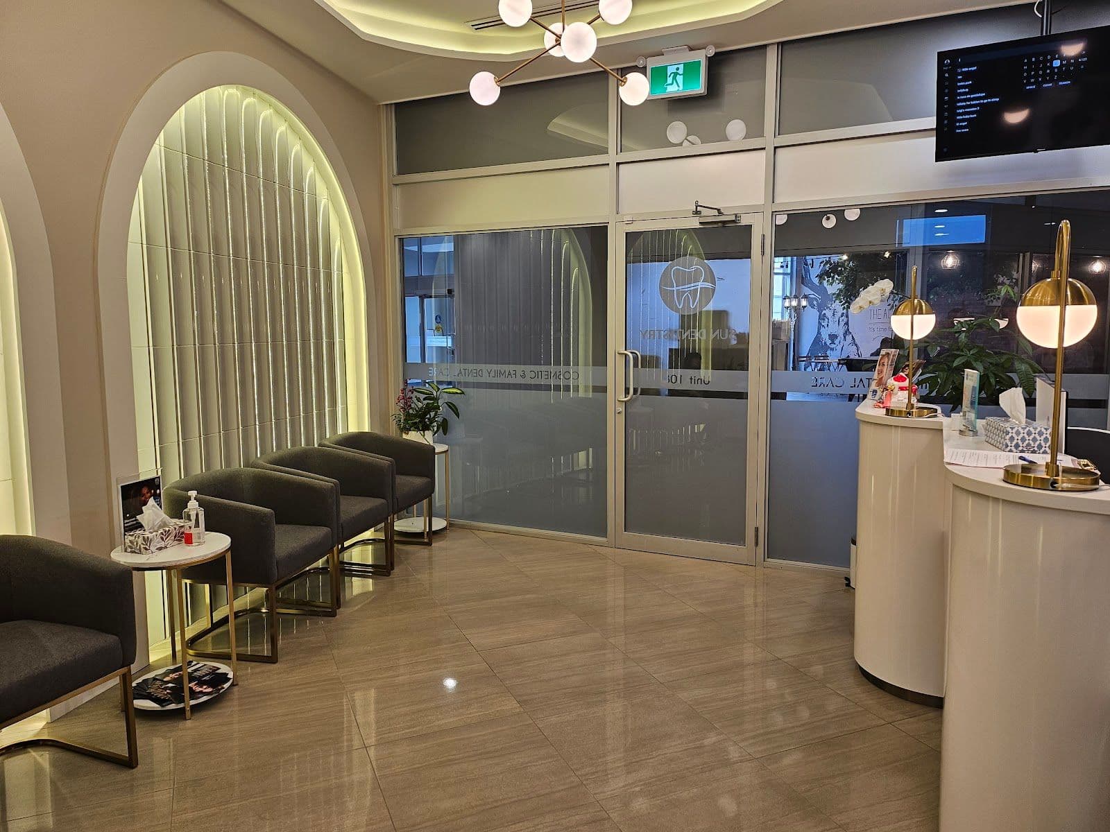 A dental clinic front desk team reviewing patient feedback on a tablet in a clean, modern treatment area