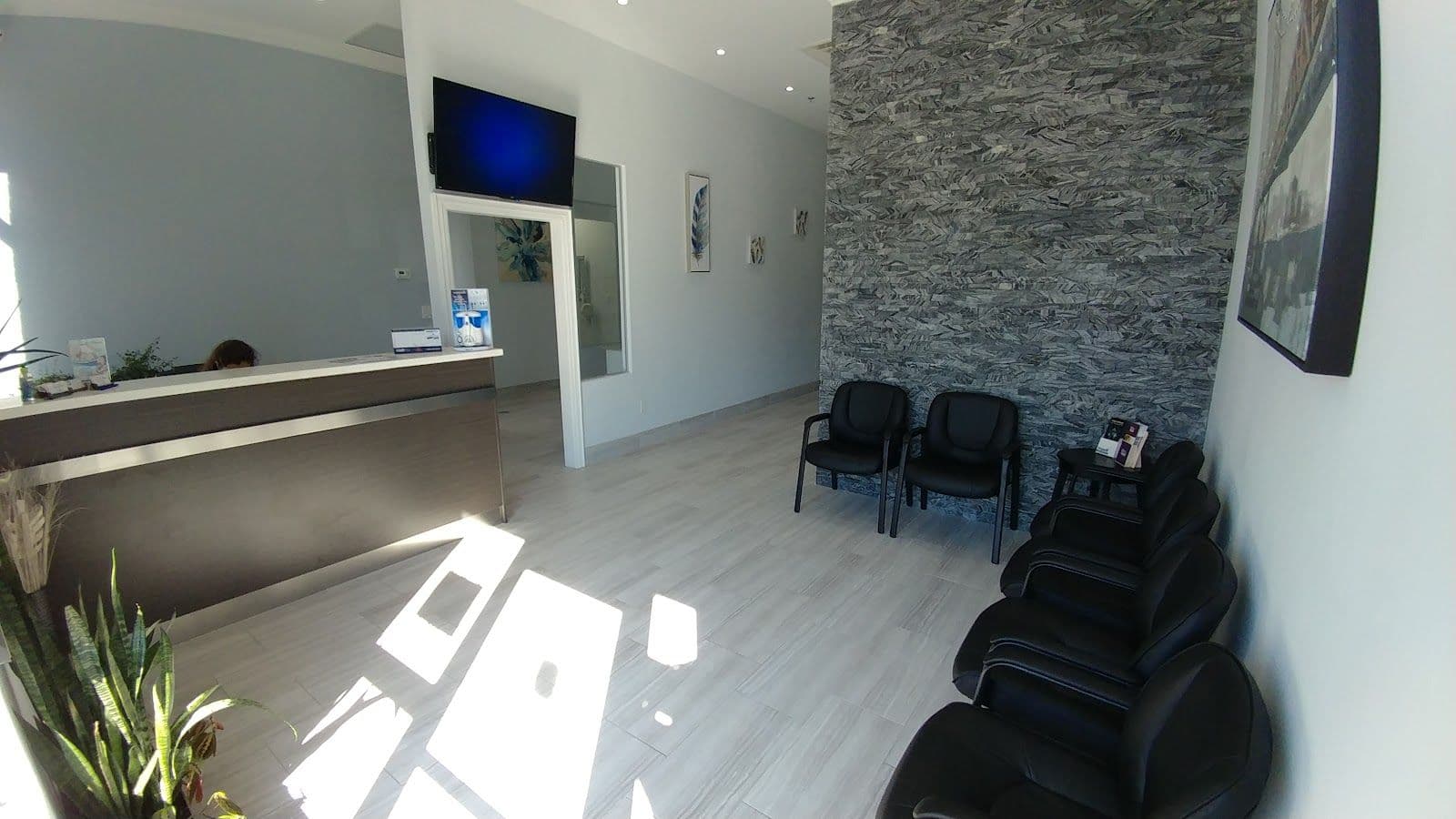 Dental clinic front desk team reviewing patient feedback and Google reviews together on a tablet at the reception area