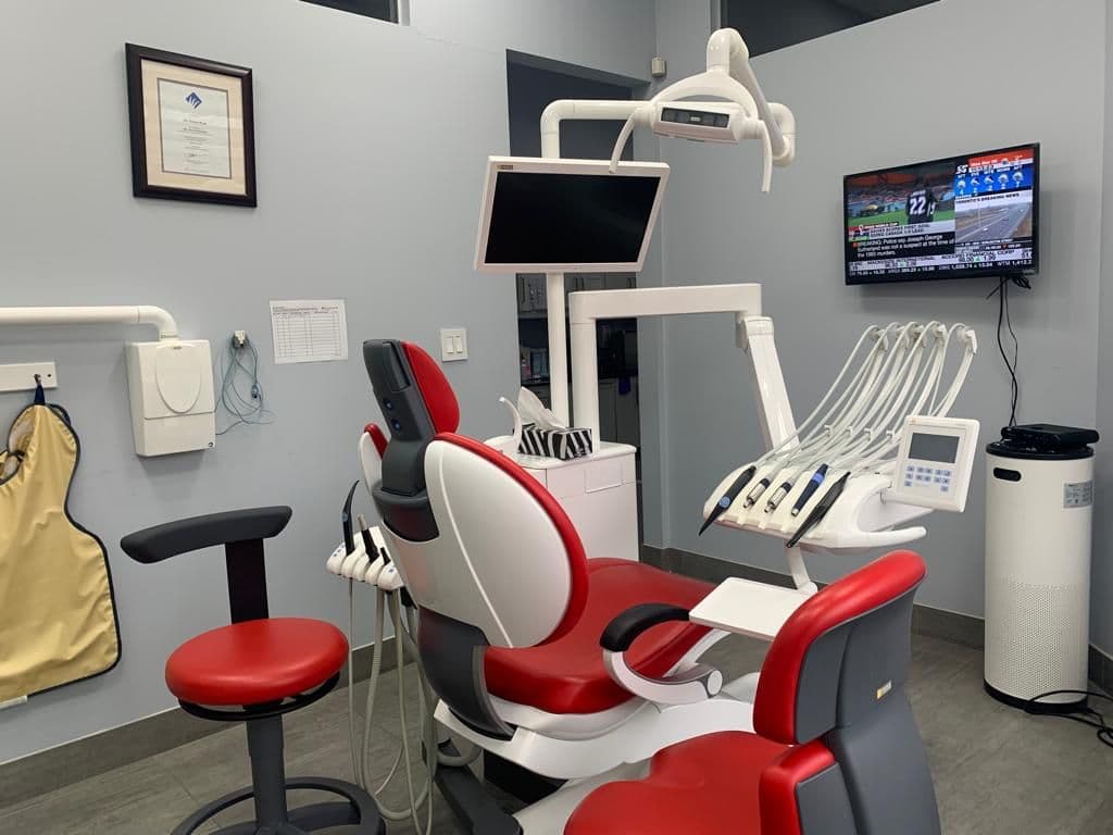 Dental clinic front desk team reviewing patient feedback on a tablet in a clean, modern reception area