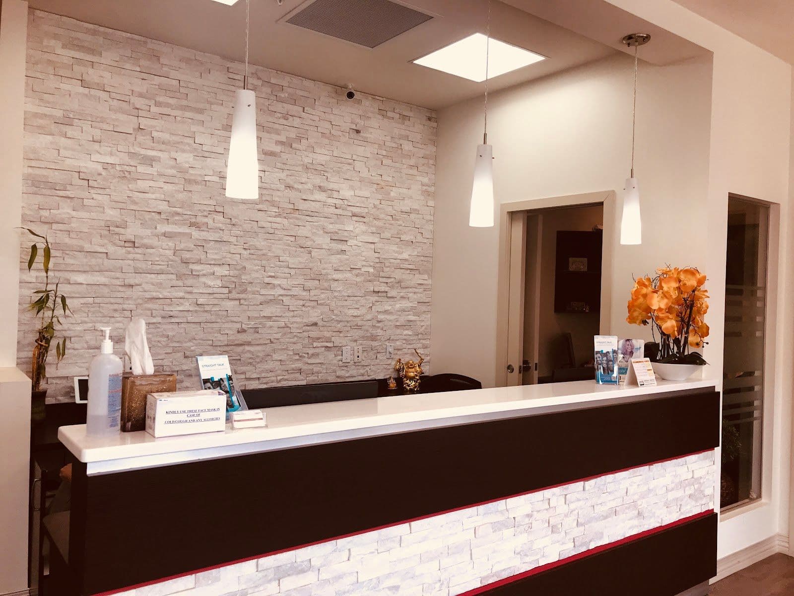 Dental clinic front desk team reviewing patient feedback together on a tablet in the reception area