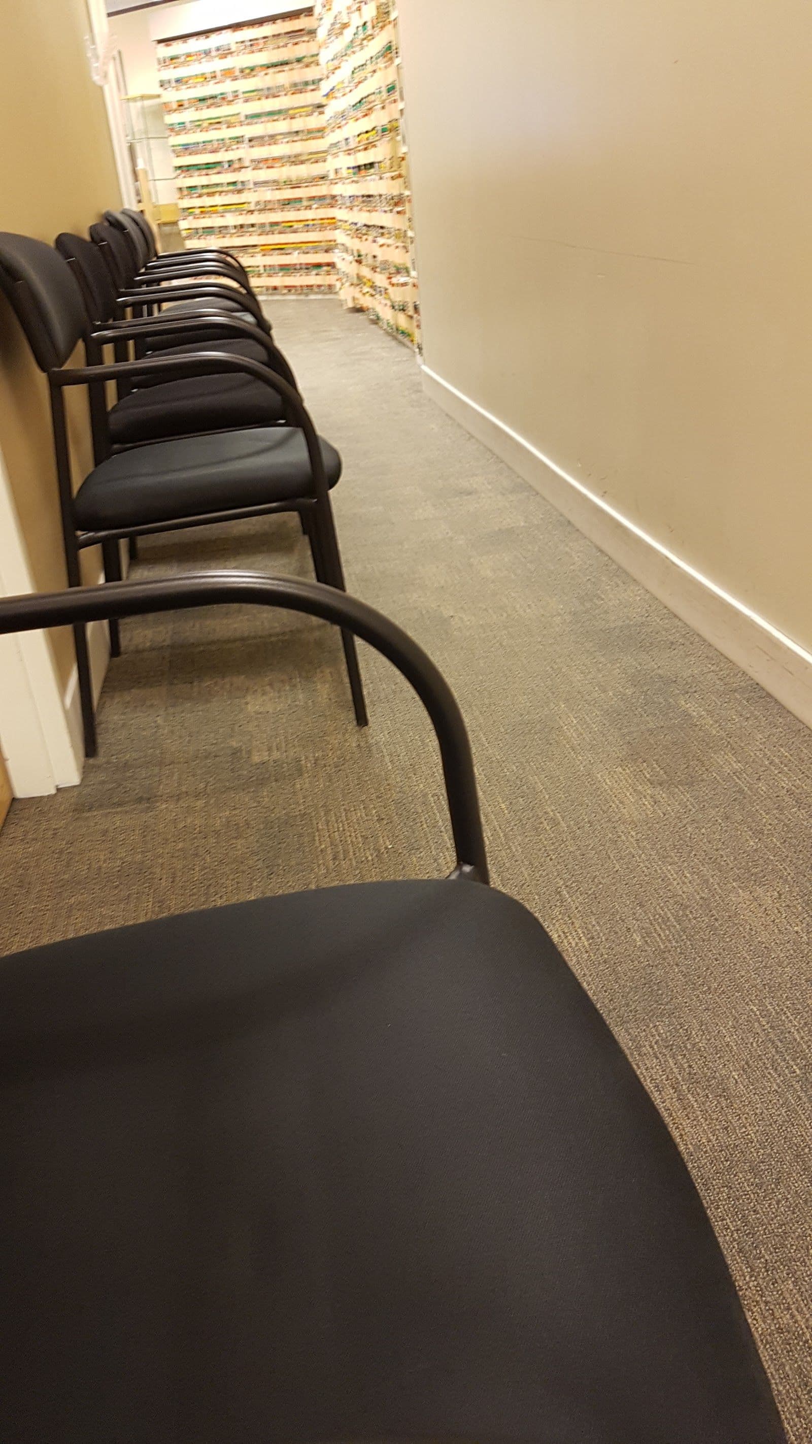 Optometry clinic front desk team reviewing patient feedback together on a tablet in a bright, modern eyecare practice