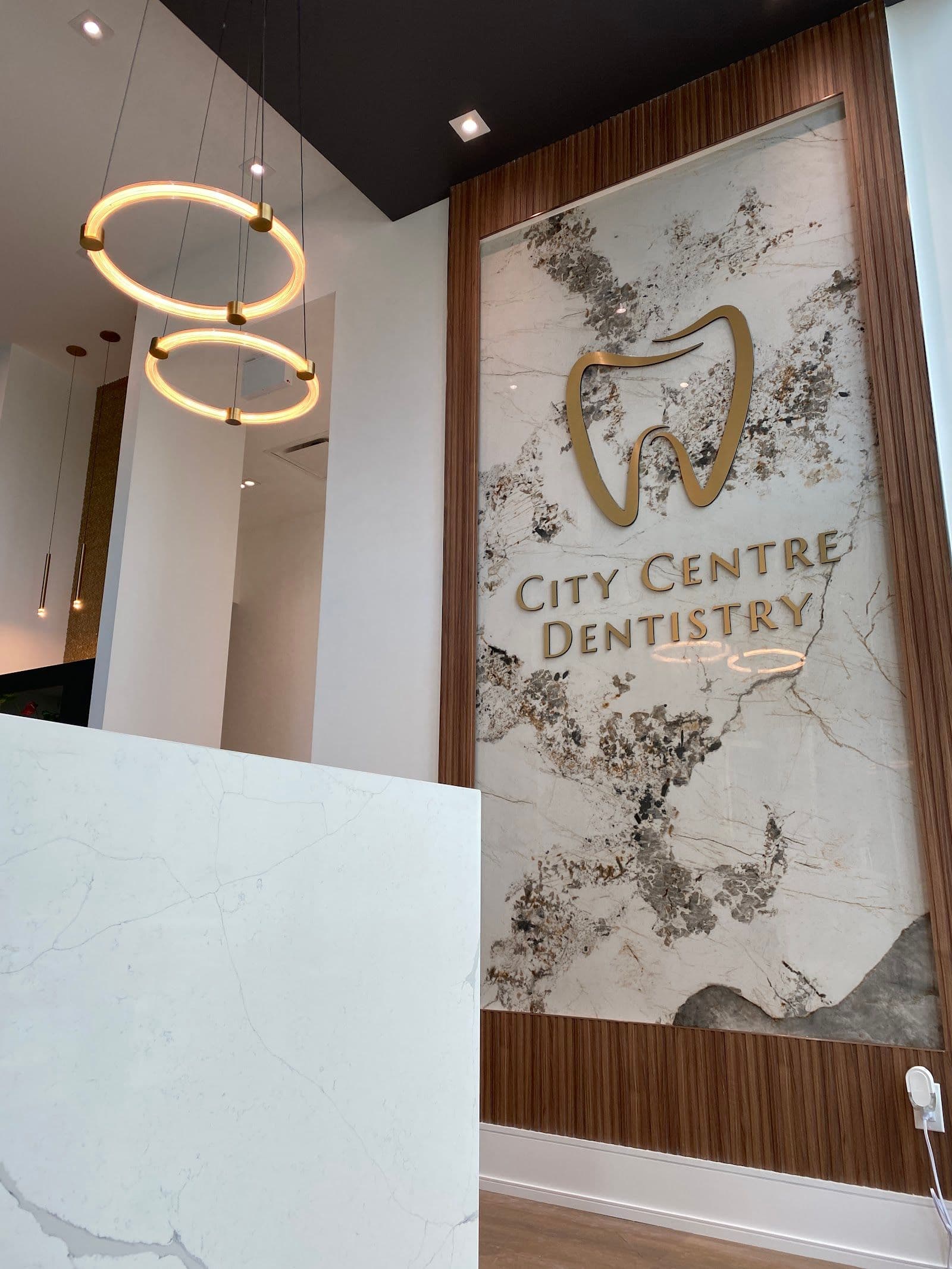 City Centre Dentistry front desk team reviewing patient feedback together on a tablet at the reception area