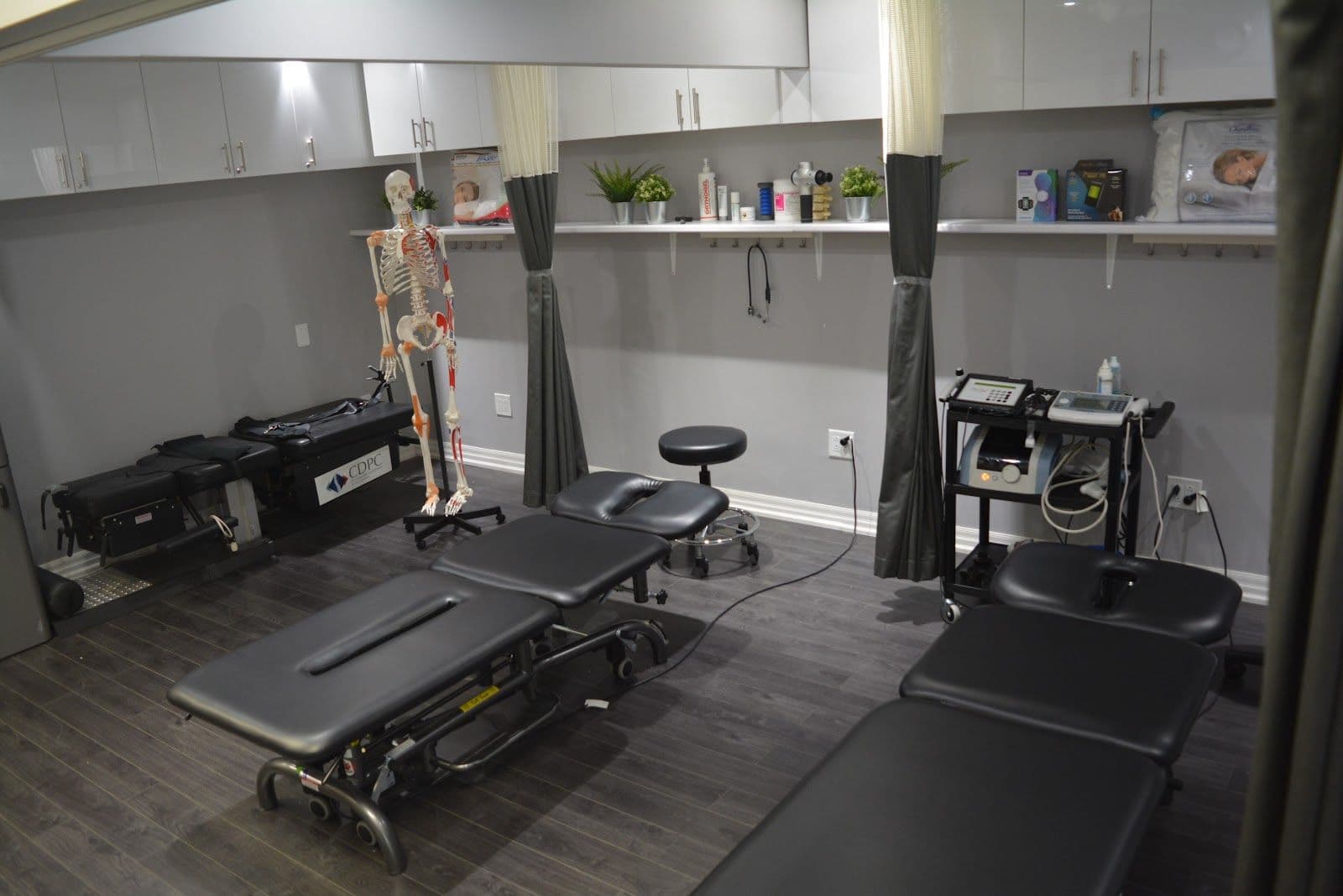 A clinic care coordinator and physiotherapist reviewing patient feedback together at the front desk of a modern rehabilitation clinic