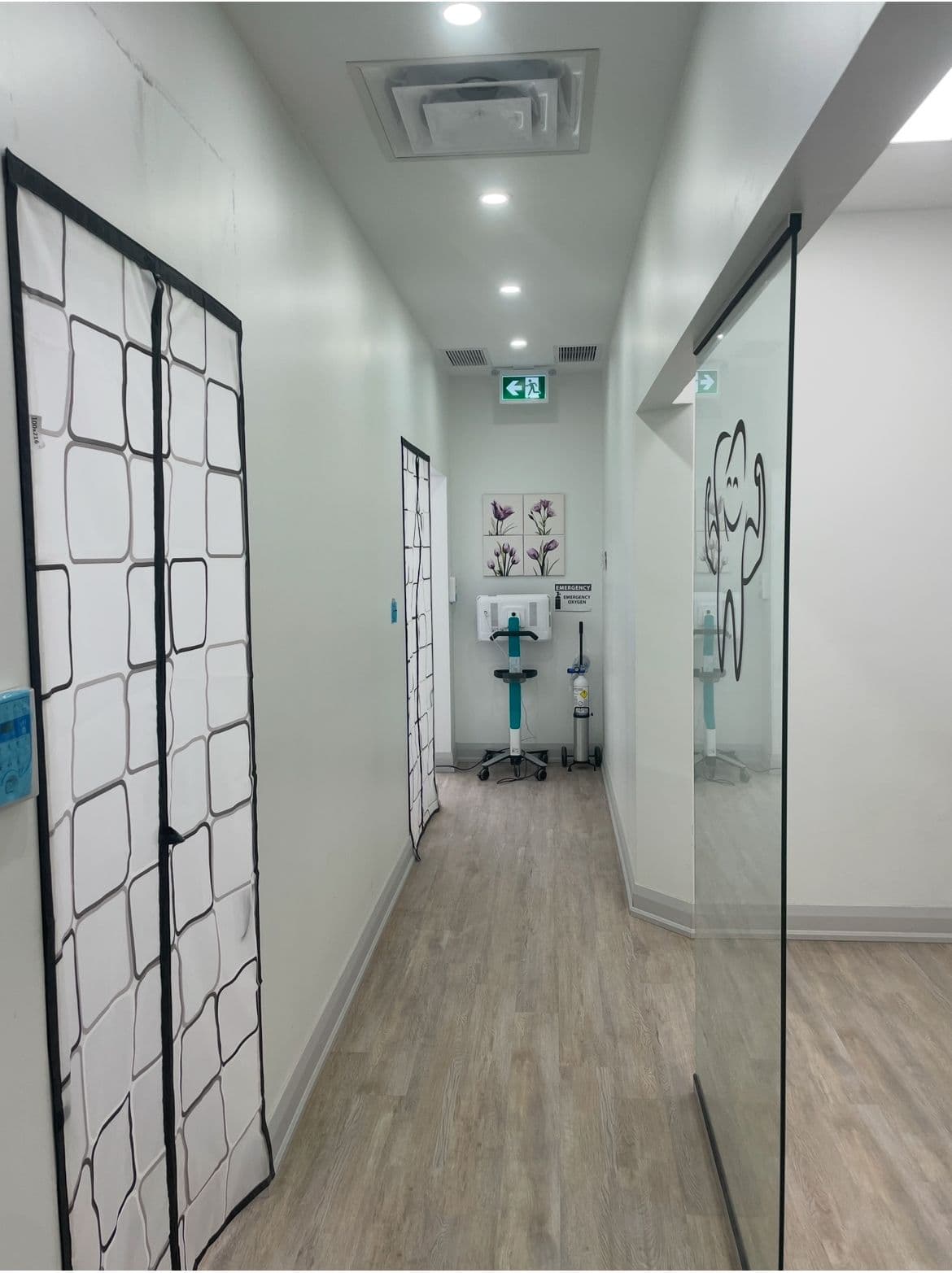 Dental clinic front desk team reviewing patient feedback together on a tablet in a clean, modern reception area
