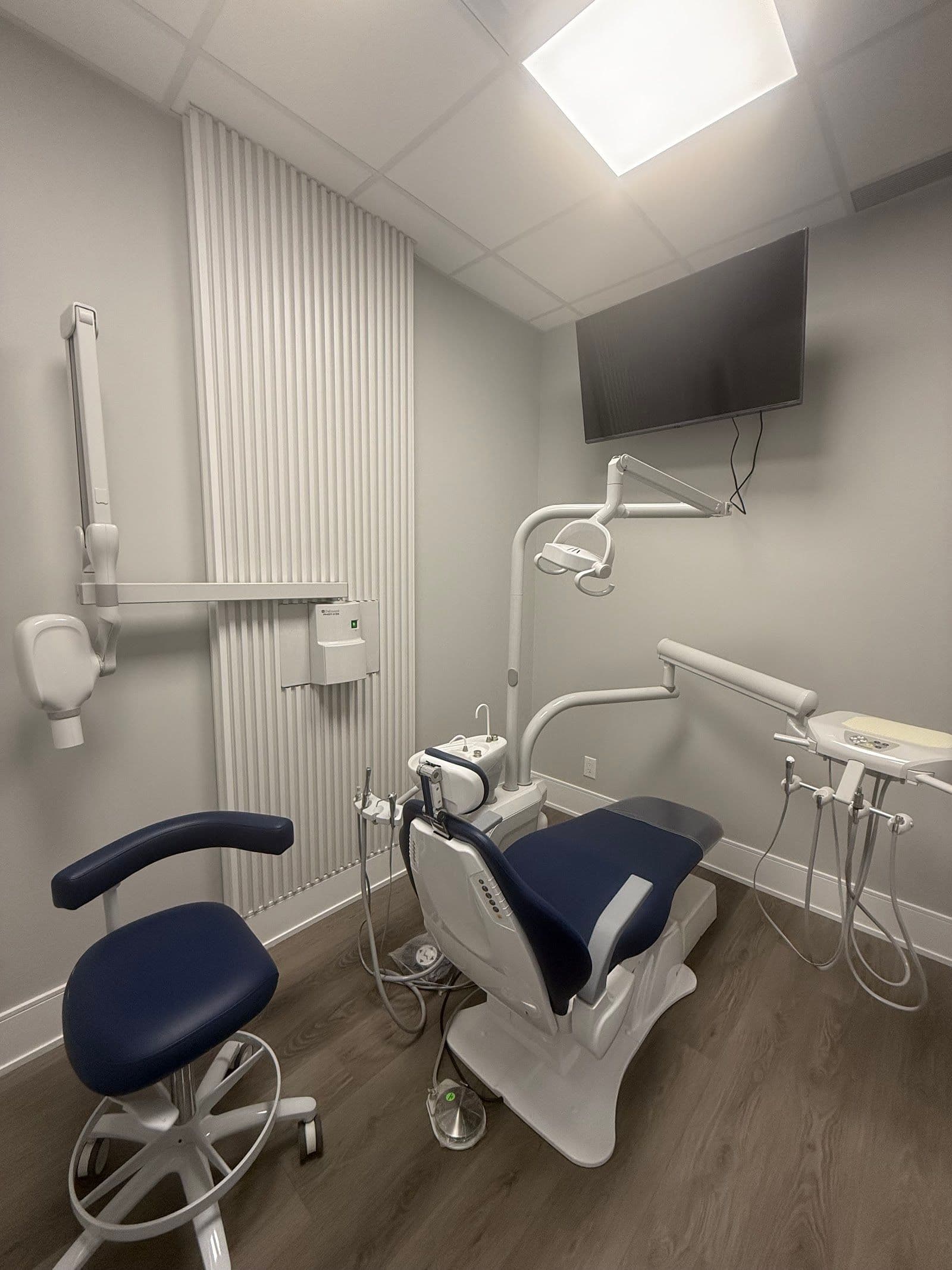 Dental clinic front desk team reviewing patient feedback together on a tablet at the reception area of Align Dental Smiles Brampton