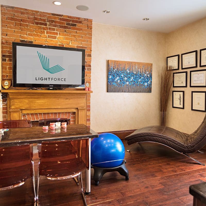 Orthodontic clinic front desk team reviewing patient feedback together on a tablet at the reception area of Heritage Orthodontics