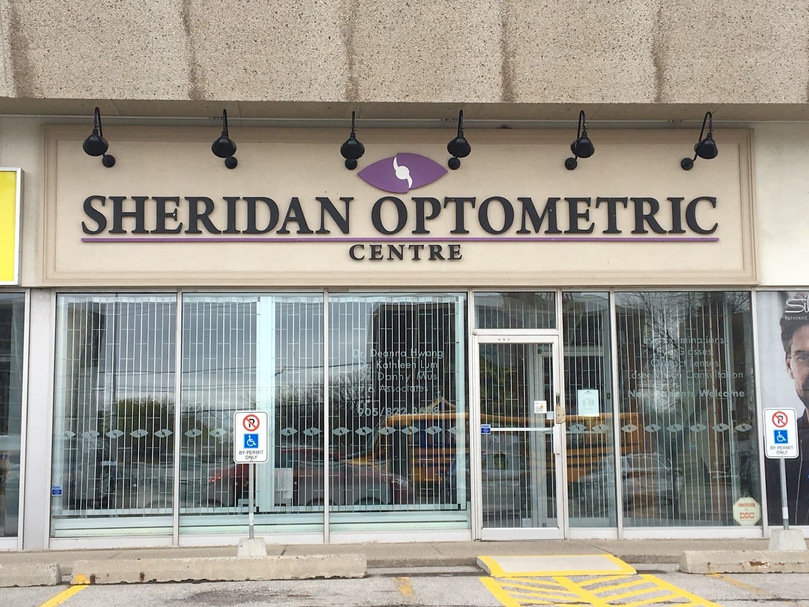 Optometry clinic team reviewing patient feedback together at the front desk of an eye care clinic