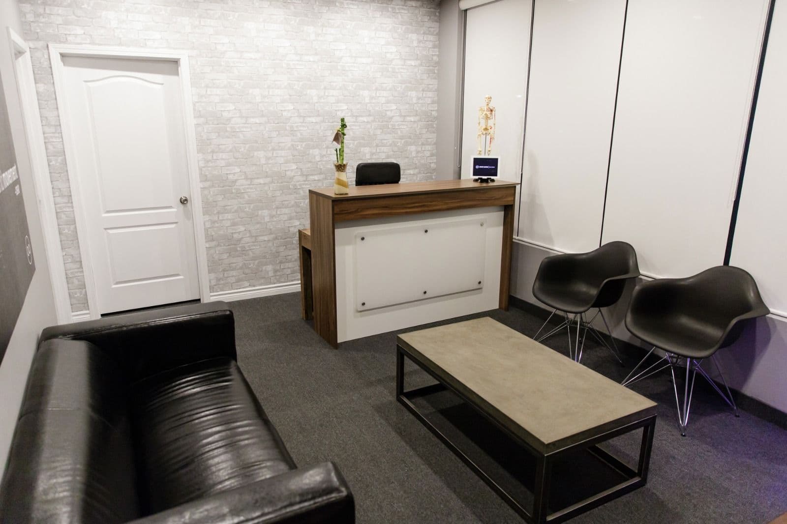 Clinic team at Infinite Motion Health reviewing patient feedback together at the front desk
