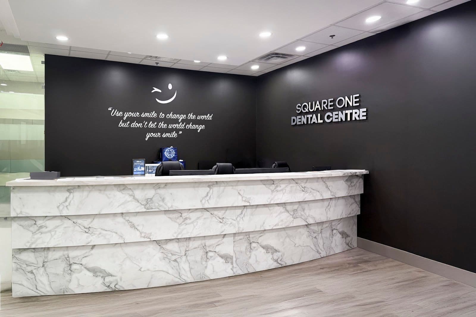 City Centre Dentistry front desk team reviewing patient feedback together on a tablet at the reception area