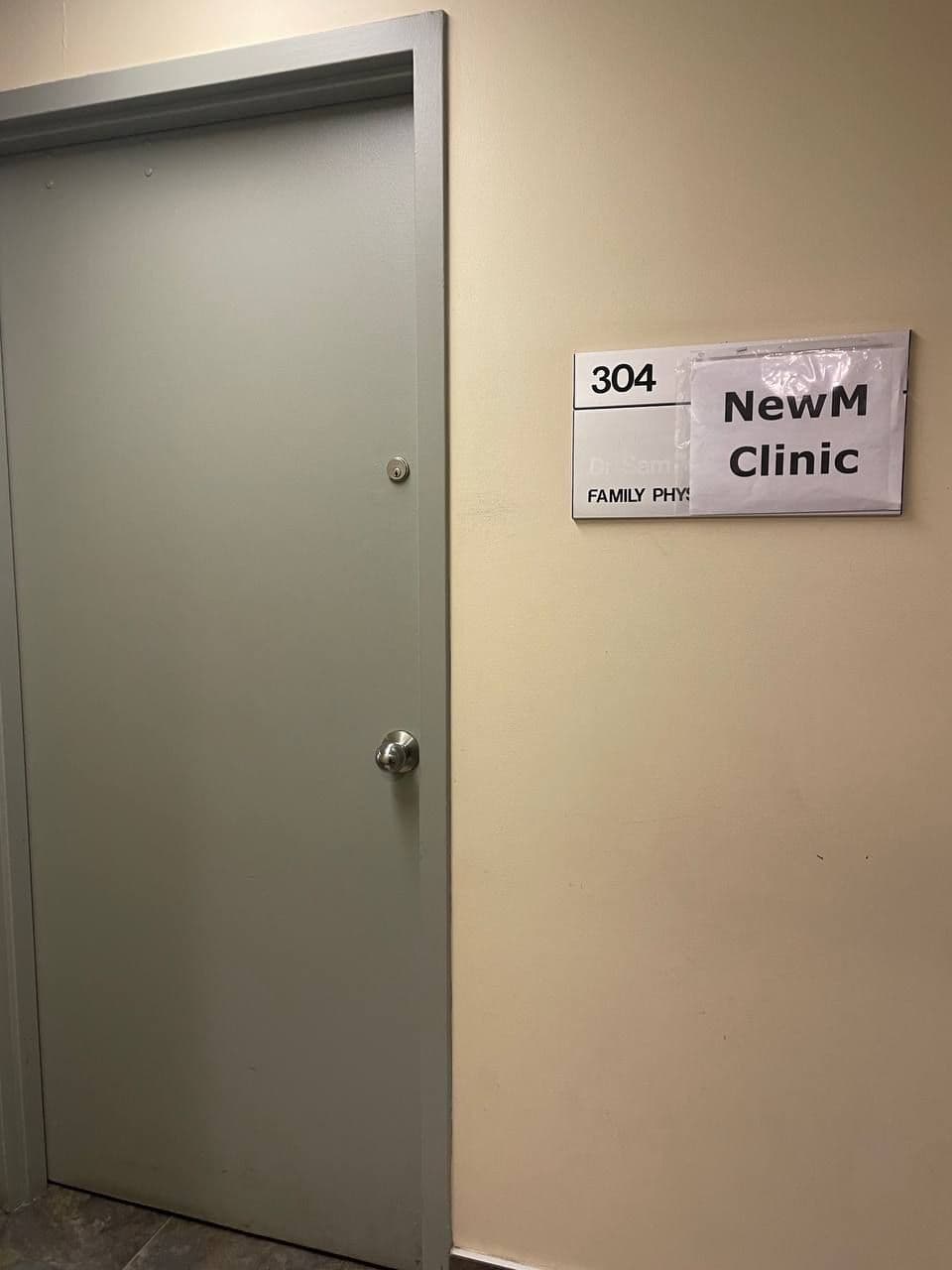 A clinic team member and practice manager reviewing patient feedback together at the front desk of a private-pay aesthetic and IV therapy clinic