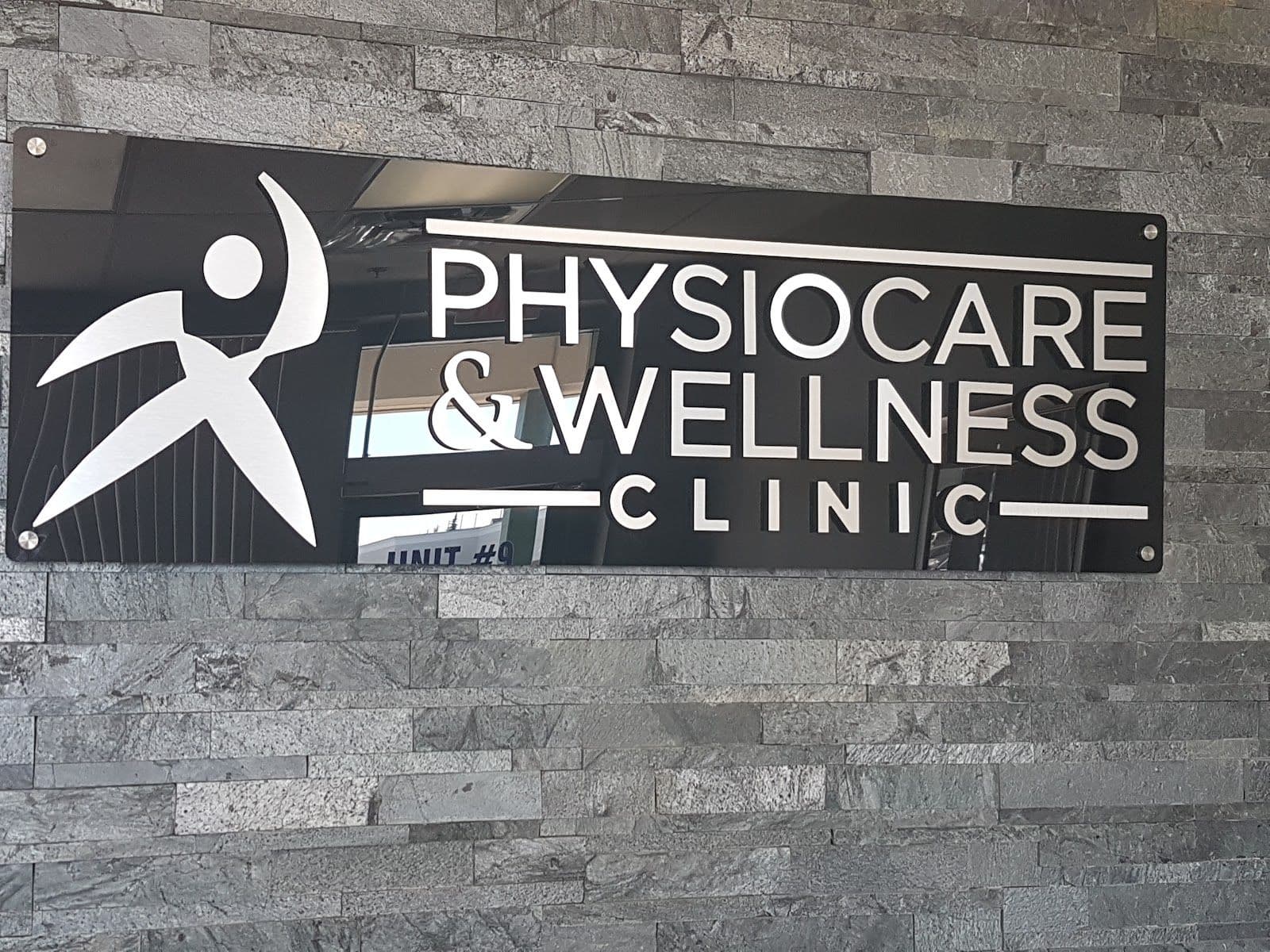 Physiotherapy clinic front desk team reviewing patient feedback together on a tablet in a clean, organized reception area
