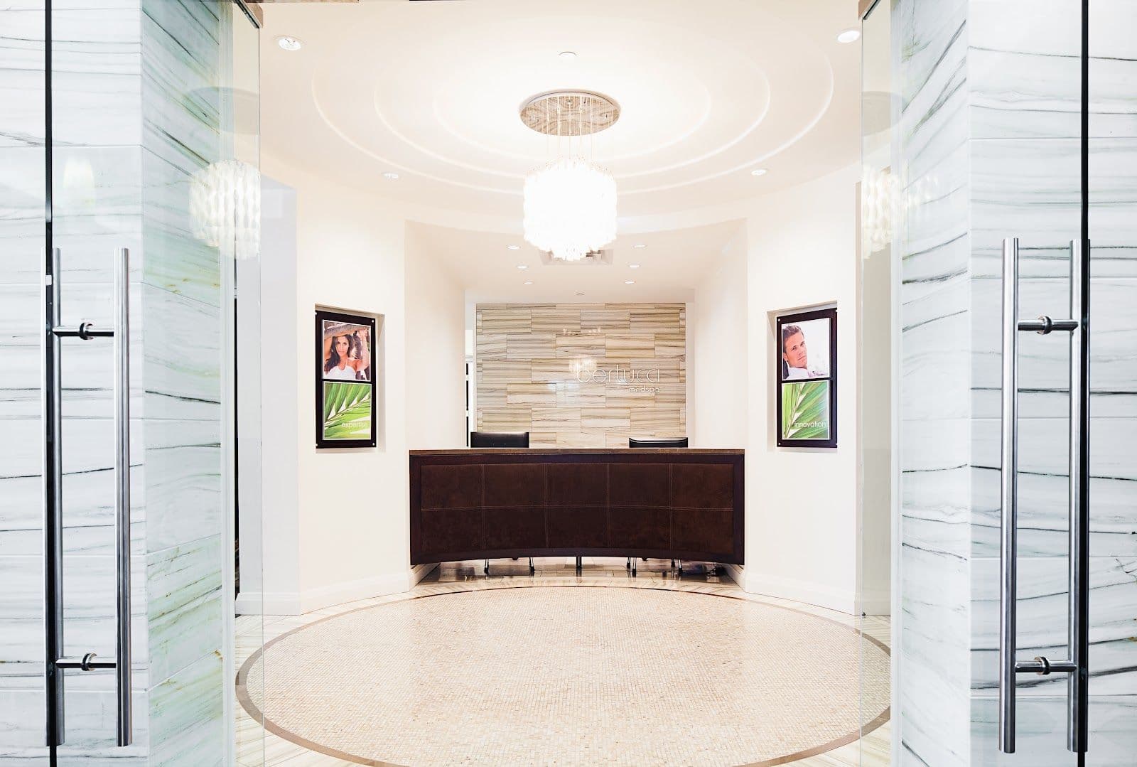A clinic team at Bertucci MedSpa reviewing patient feedback and Google reviews together at the front desk