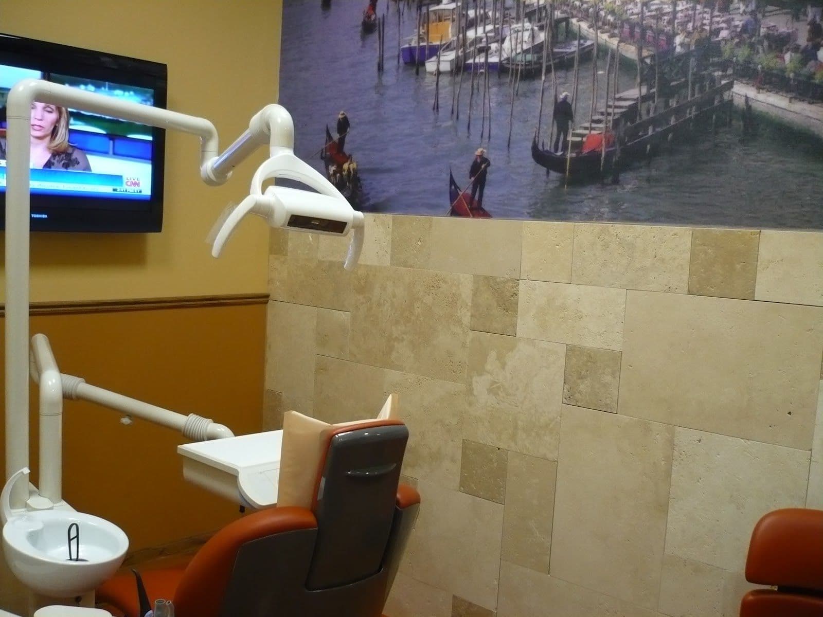 Dental clinic front desk team reviewing patient feedback together on a tablet at the reception counter