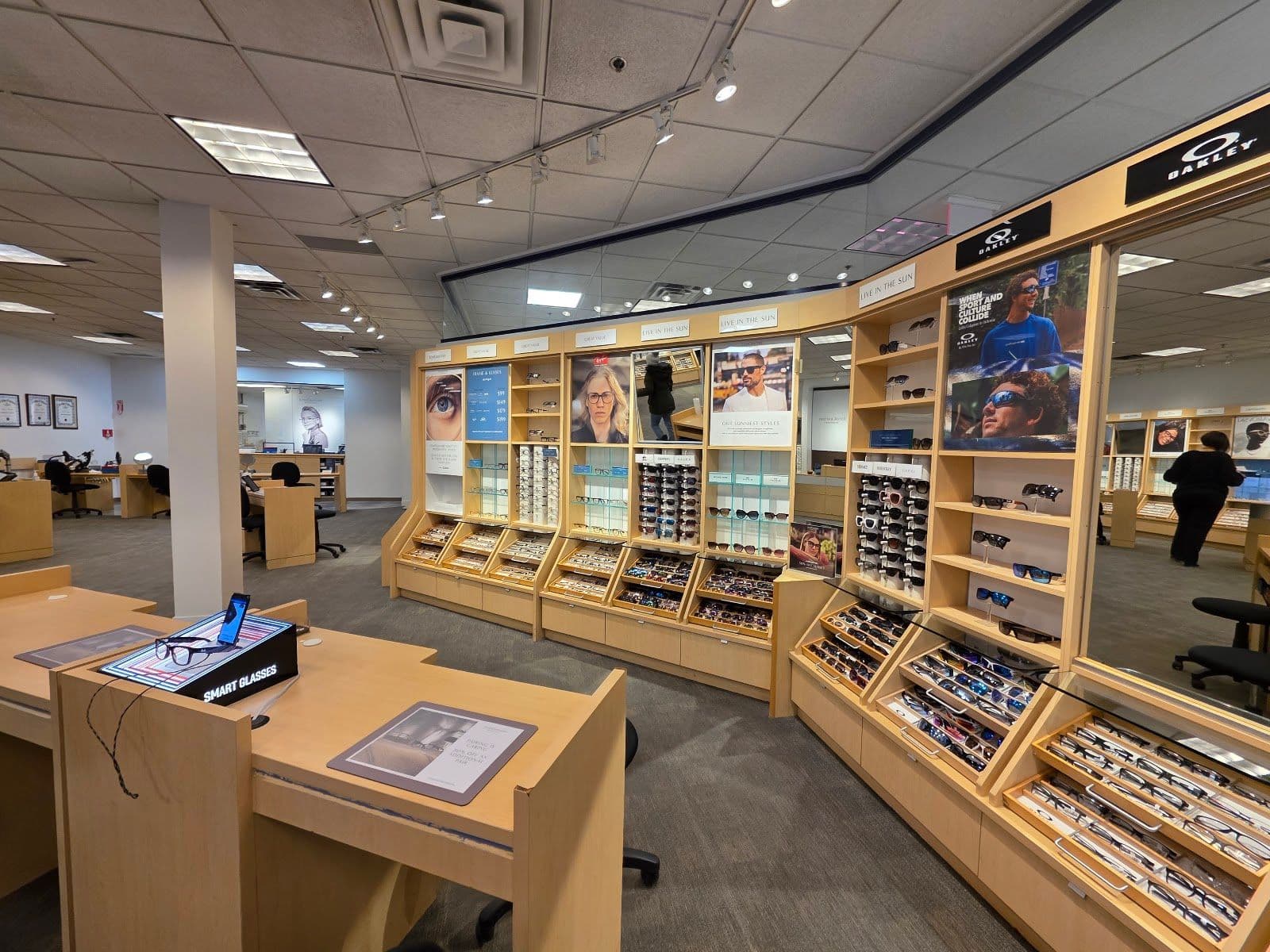 Optometry clinic team reviewing patient feedback and Google reviews together at the front desk display area
