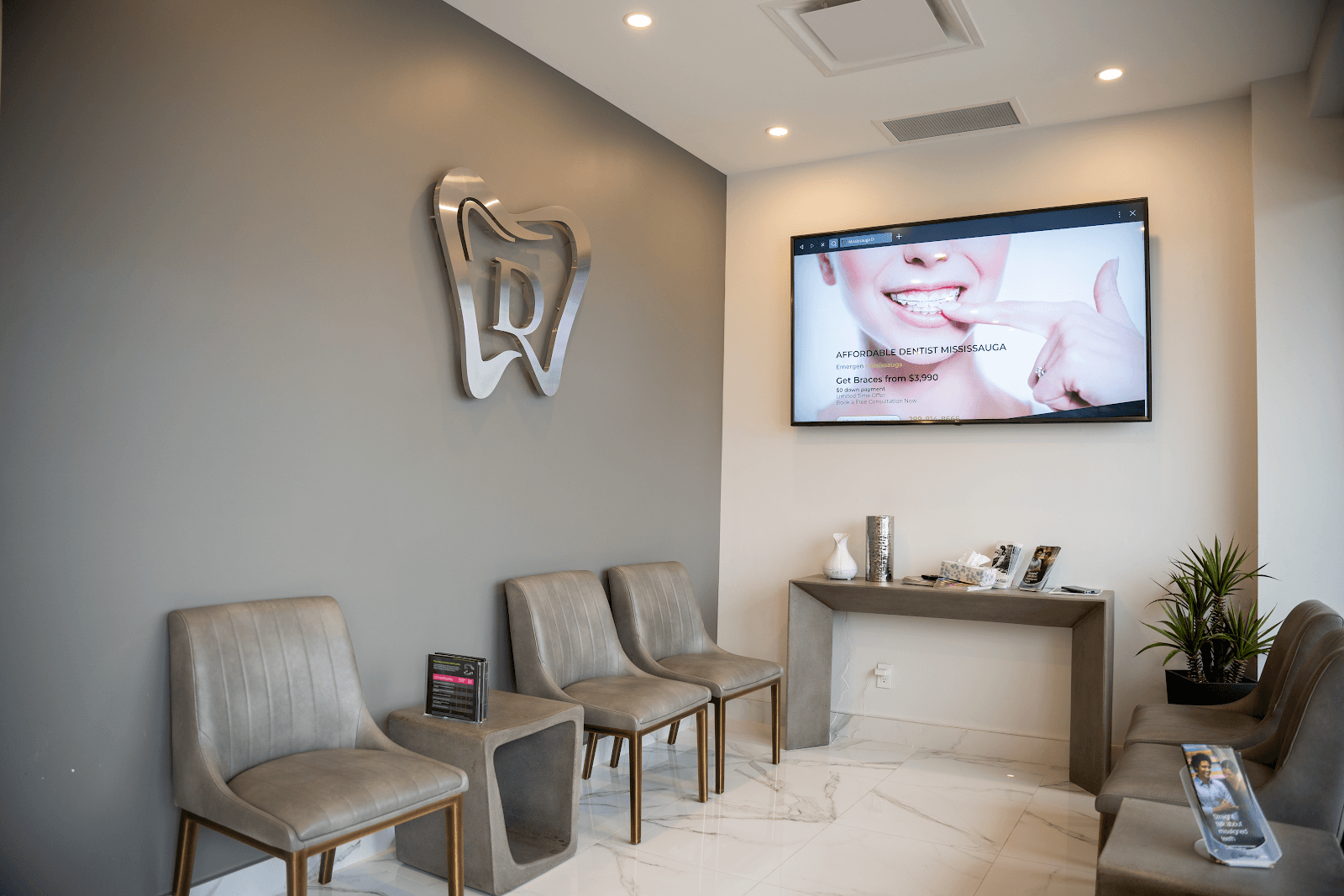 A dental clinic front desk team reviewing patient feedback together on a tablet, with a clean and welcoming reception area in the background
