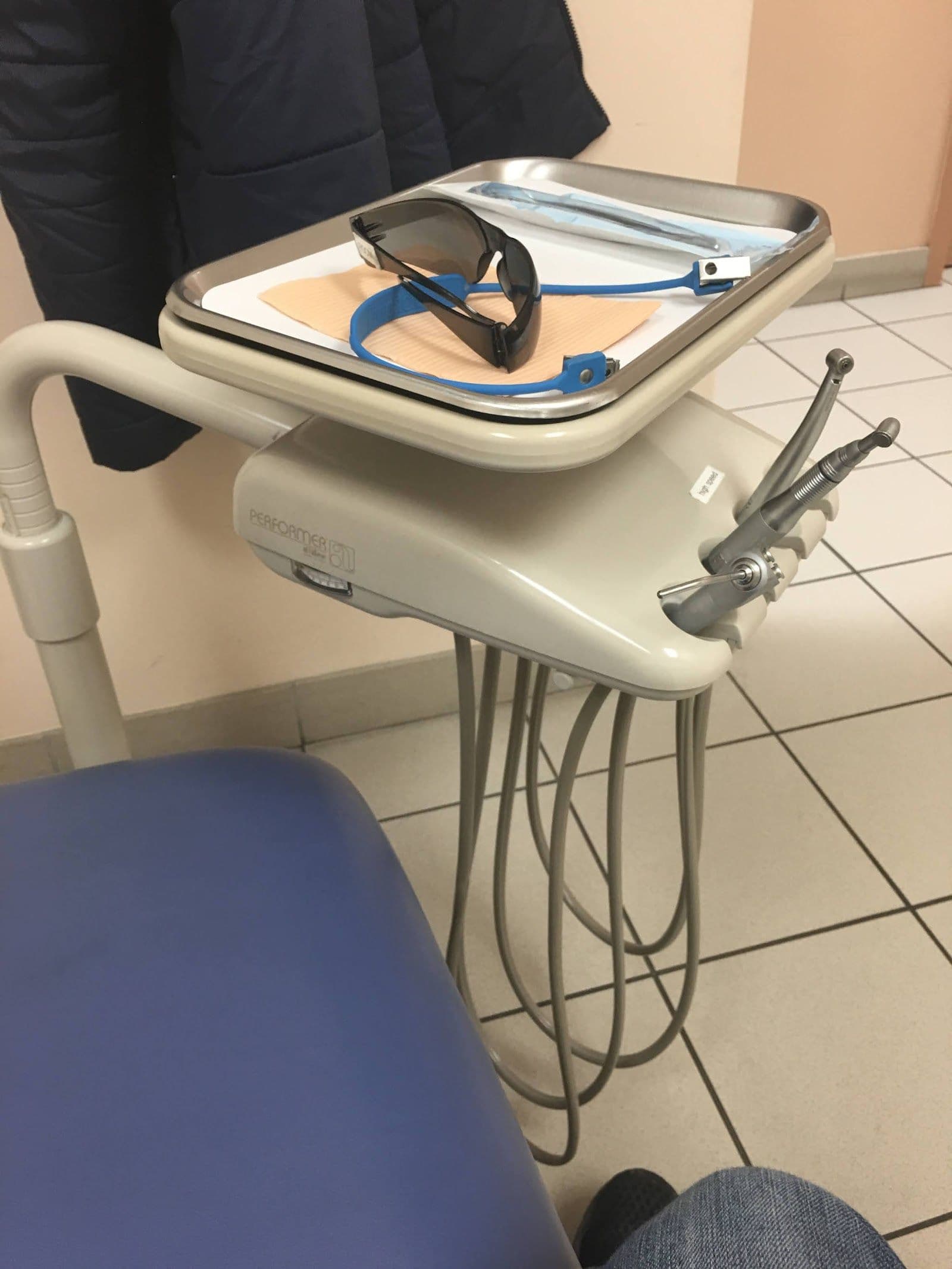 Dental clinic front desk team reviewing patient feedback and Google reviews together on a tablet at the reception area
