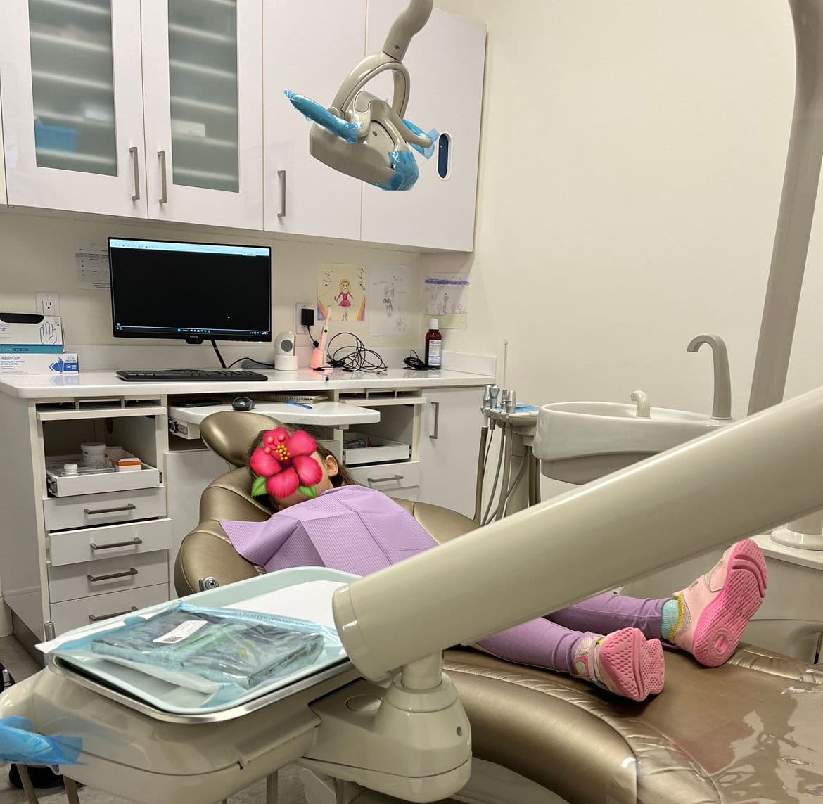 Dental clinic front desk team reviewing patient feedback together on a tablet in a clean, professional reception area