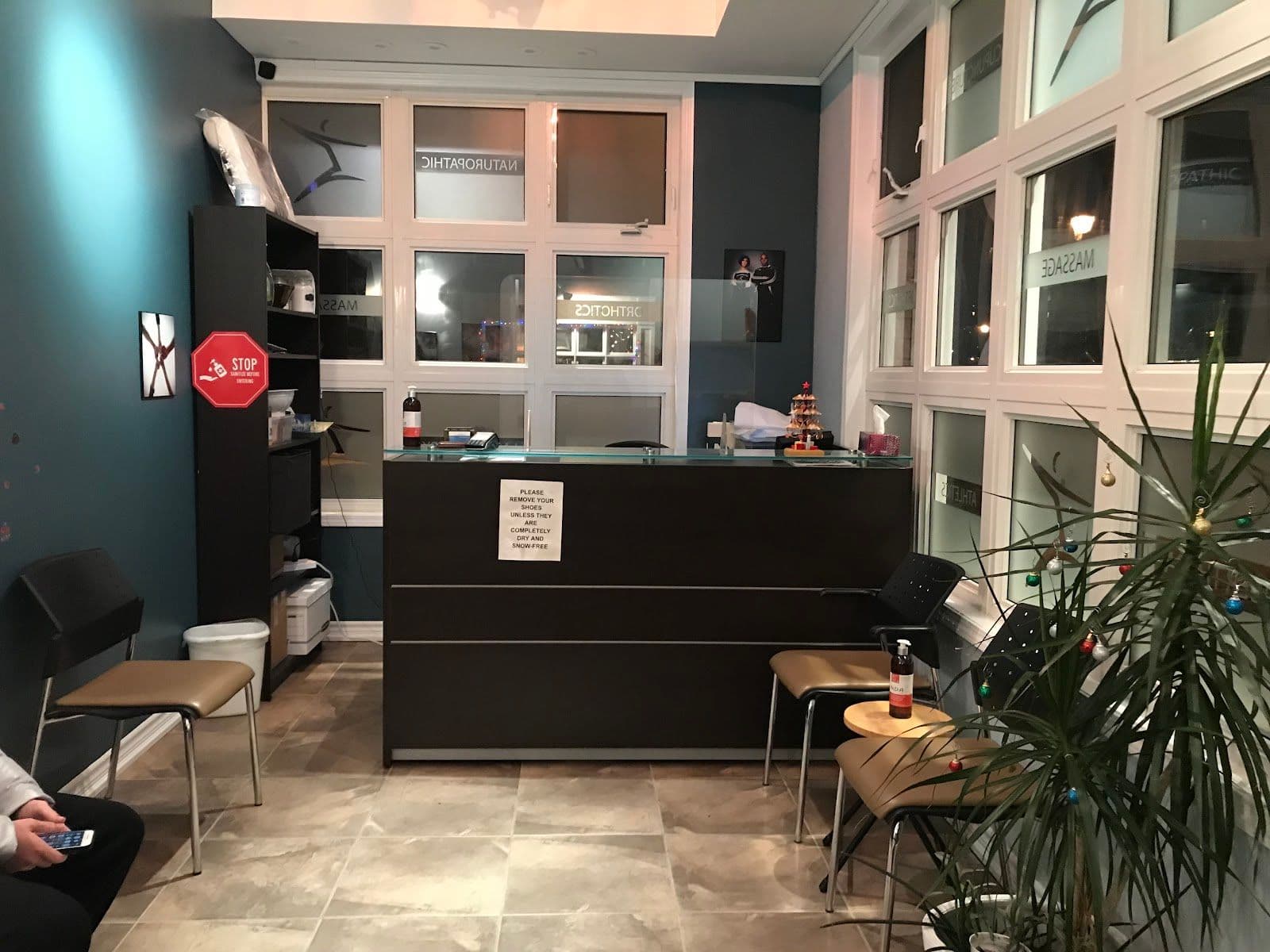 Chiropractic clinic front desk team reviewing patient feedback together on a tablet at the reception area of Cornell Chiropractic Centre