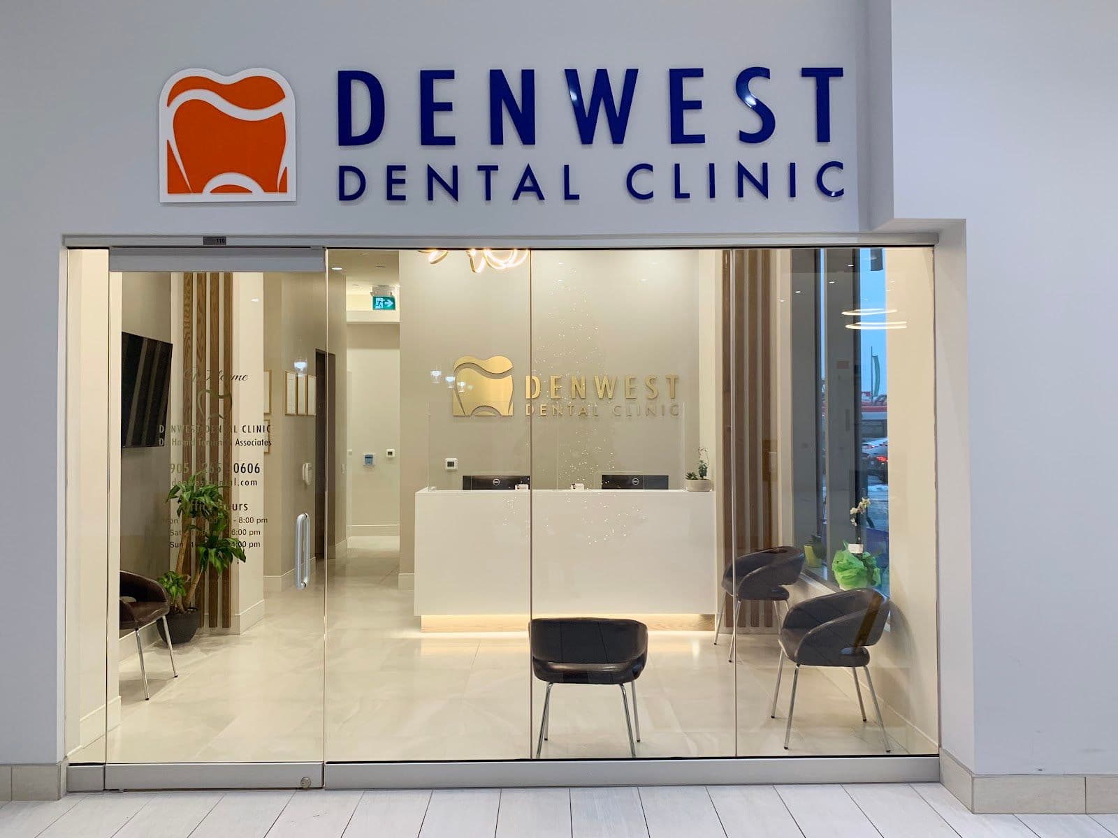Dental clinic front desk team reviewing patient feedback together on a tablet in a clean, modern reception area